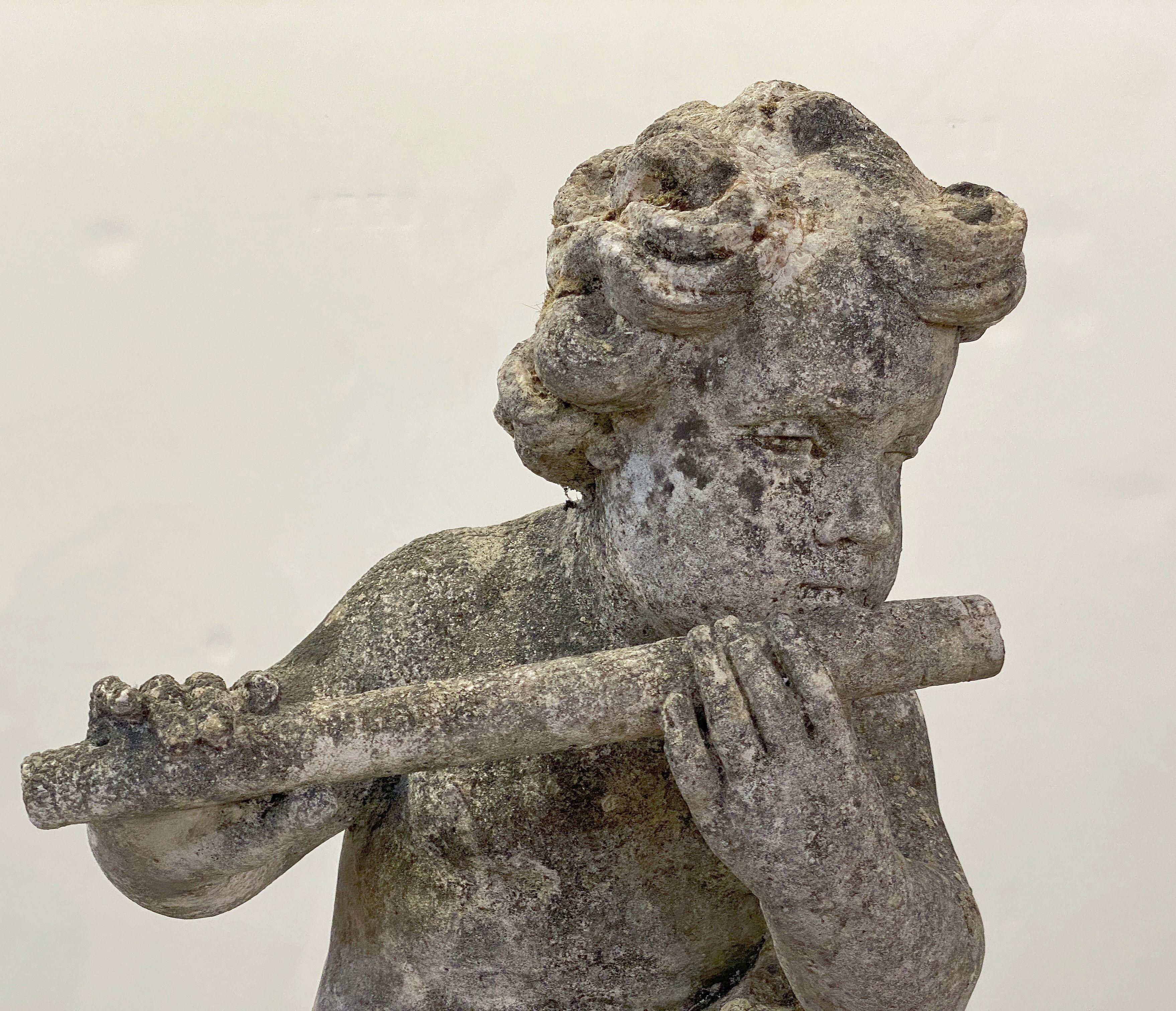 English Garden Stone Figure of a Child Putti Playing Flute on a Plinth Base In Good Condition For Sale In Austin, TX