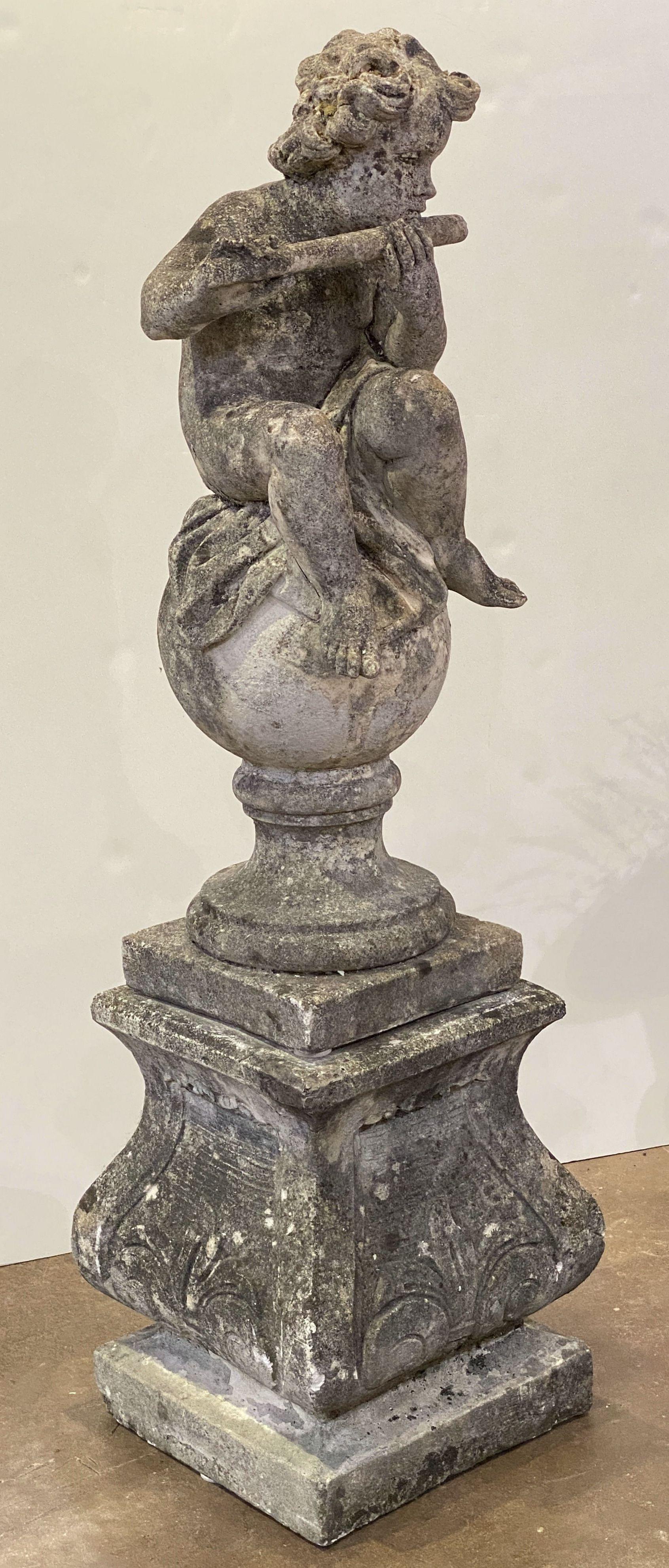 Cast Stone English Garden Stone Figure of a Child Putti Playing Flute on a Plinth Base For Sale