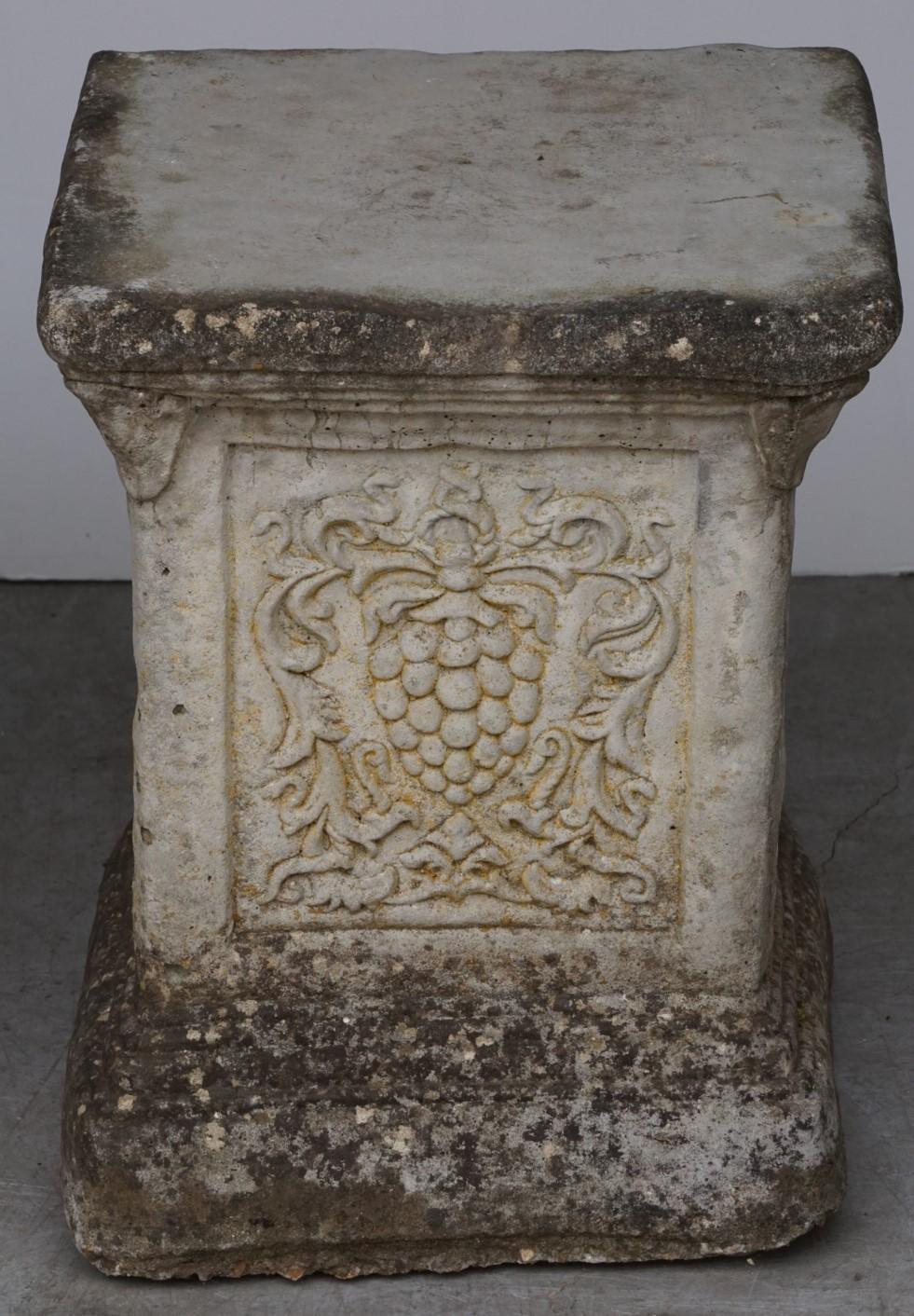 A fine English garden plinth or pedestal of composition stone for use as an ornamental garden feature or display pedestal. The plinth featuring a square top over four sides with a relief of grapes on the panel.

