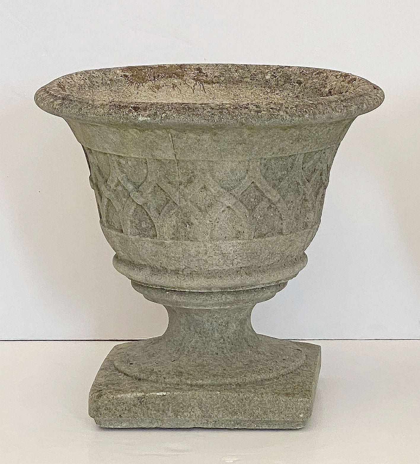 A pair of fine English garden planters or (jardinière) urns of composition stone, each pot featuring a stylized Celtic lattice or ribbon raised relief around the circumference.

Perfect for a garden room or conservatory.

Dimensions of each pot: