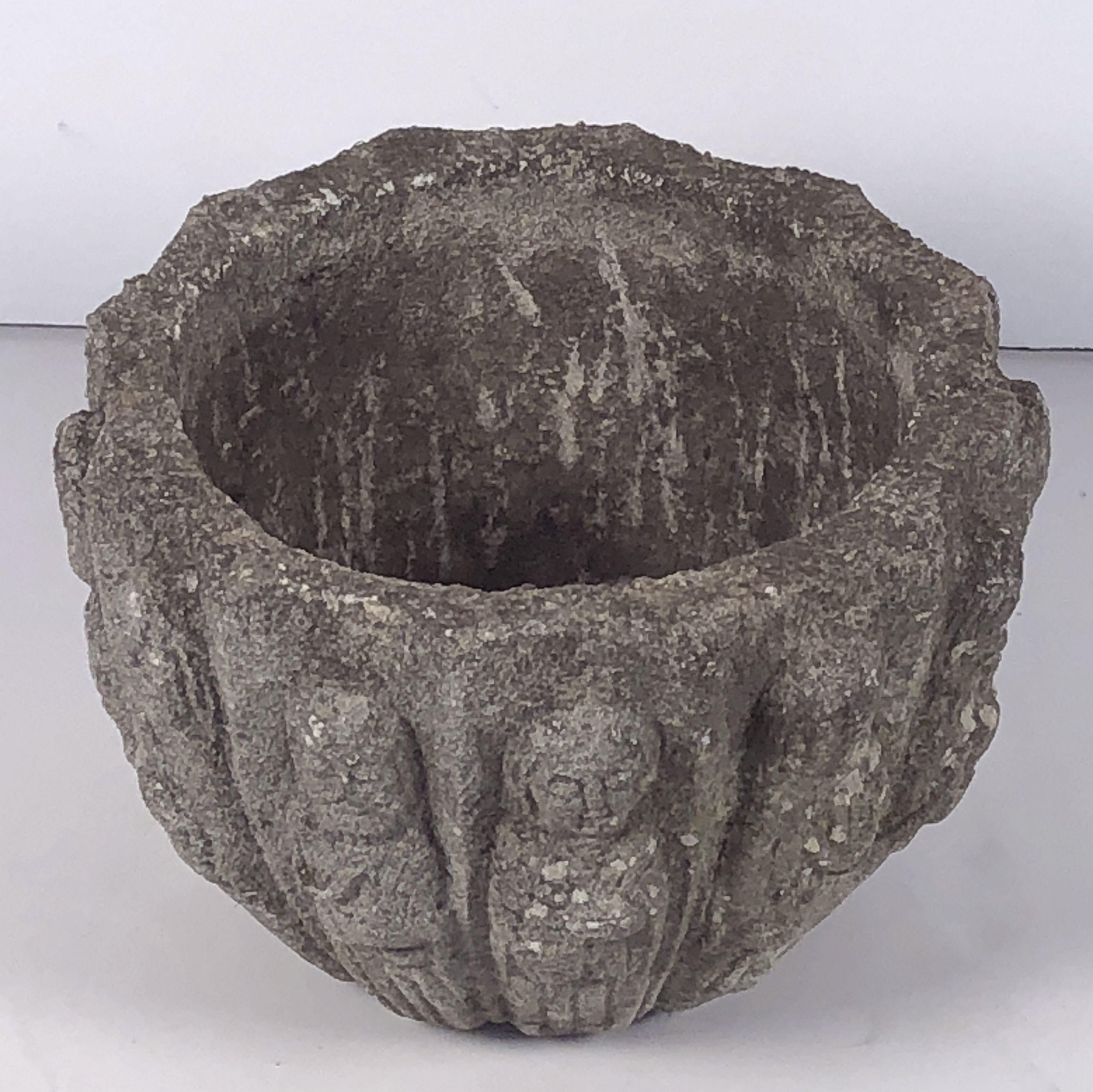 A fine English circular garden pot or planter urn of composition stone, featuring a weathered exterior relief of the Twelve Apostles around the circumference.

A compelling addition to an indoor or outdoor garden room, garden, or patio.