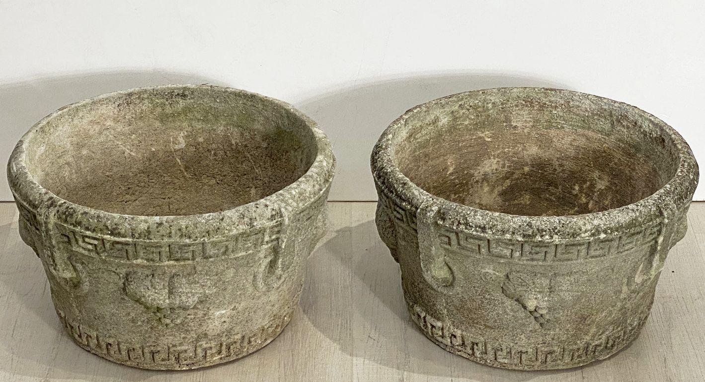 A fine pair of English round garden urns or planter pots of composition stone, each planter featuring a relief Greek Key design and grape clusters around the circumference.

Two available, individually priced, $1495 each planter.