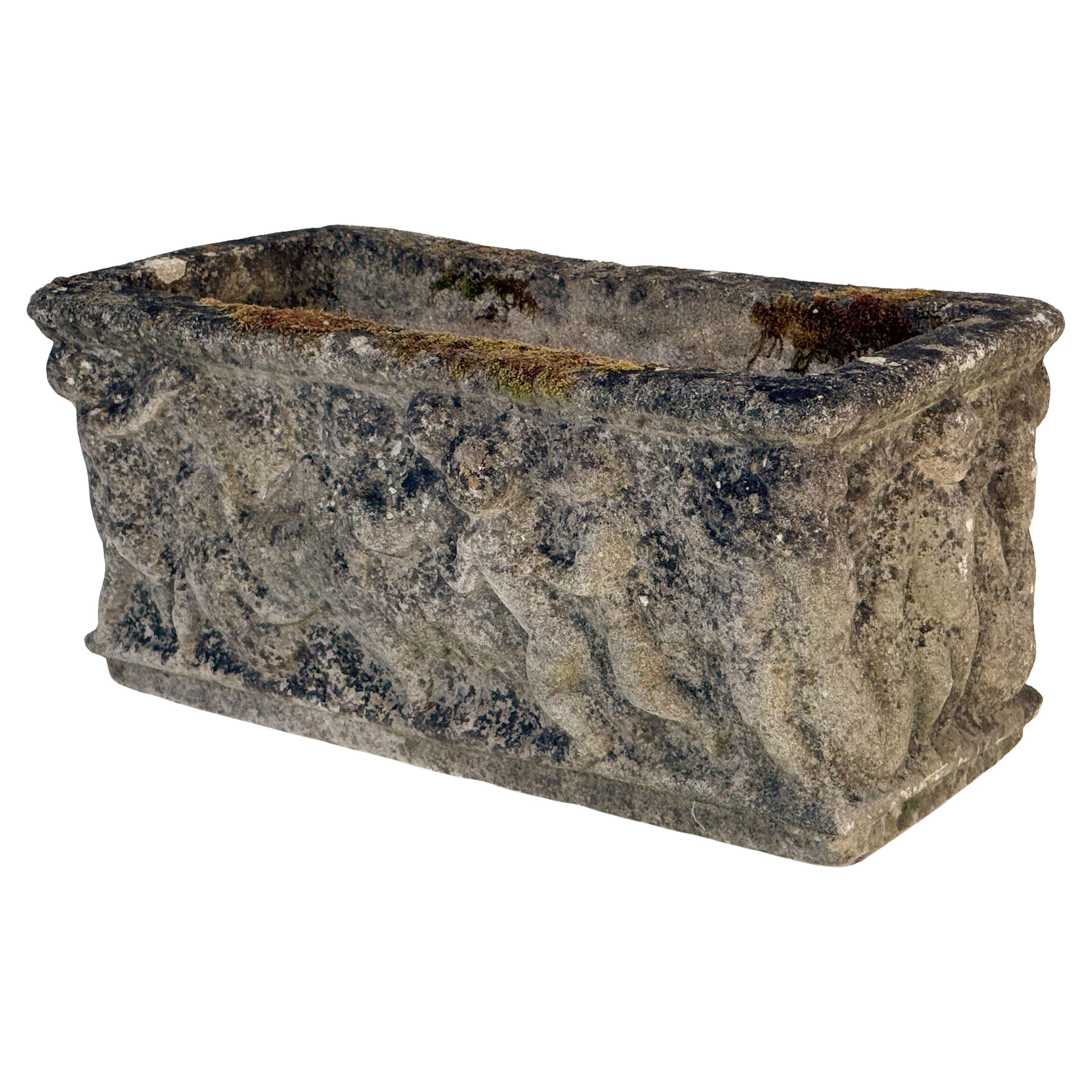A fine English rectangular garden trough of planter with an ornamental Classical relief of cherubs on all four sides.

Two available - Priced individually - $1695 Each Planter