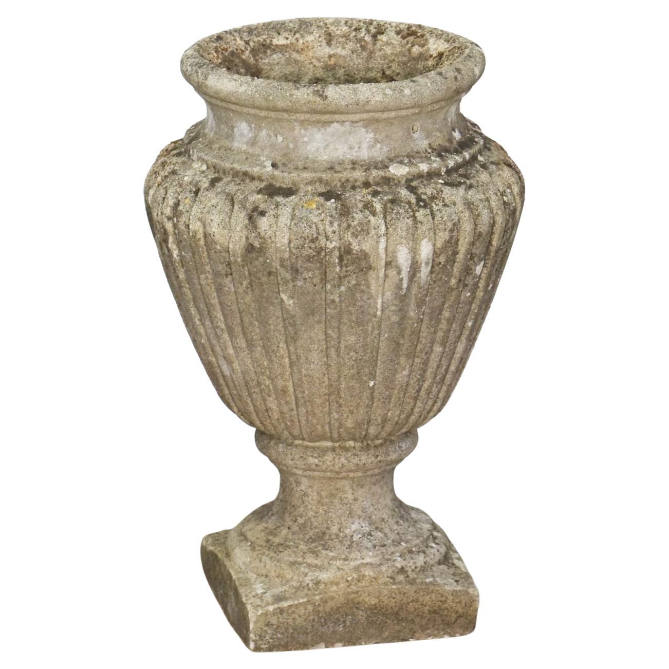 A pair of fine English garden urn vases or planter pots of composition stone from the early 20th century - each urn featuring a flared circular opening over a fully-lobed body and standing on a square base.

Two available - Individually priced -