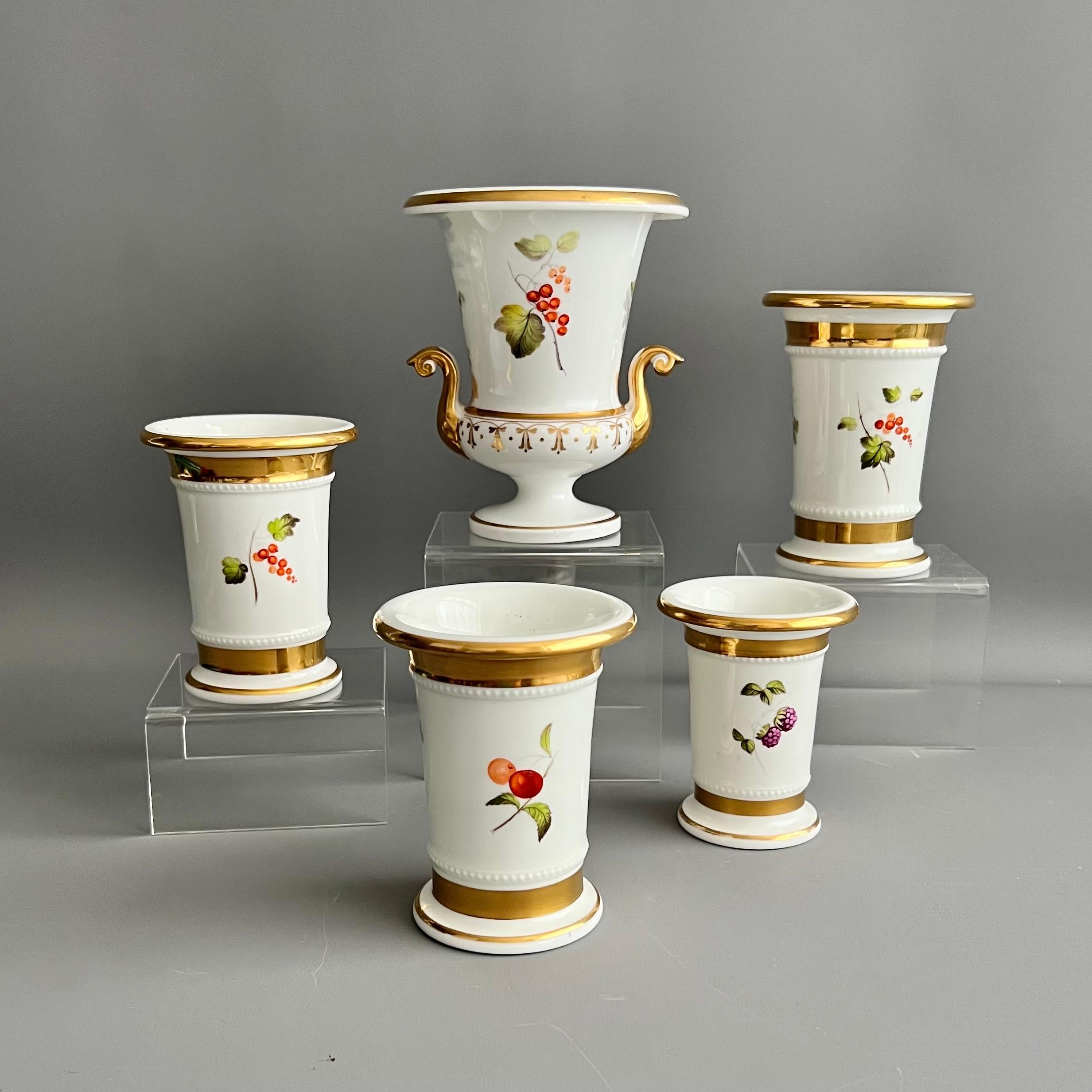 This is a beautiful garniture of five vases made by an unknown English maker in about 1820-1825. The garniture consists of one campana vase and four differently sized spill vases. The vases are white with beautiful hand painted fruit