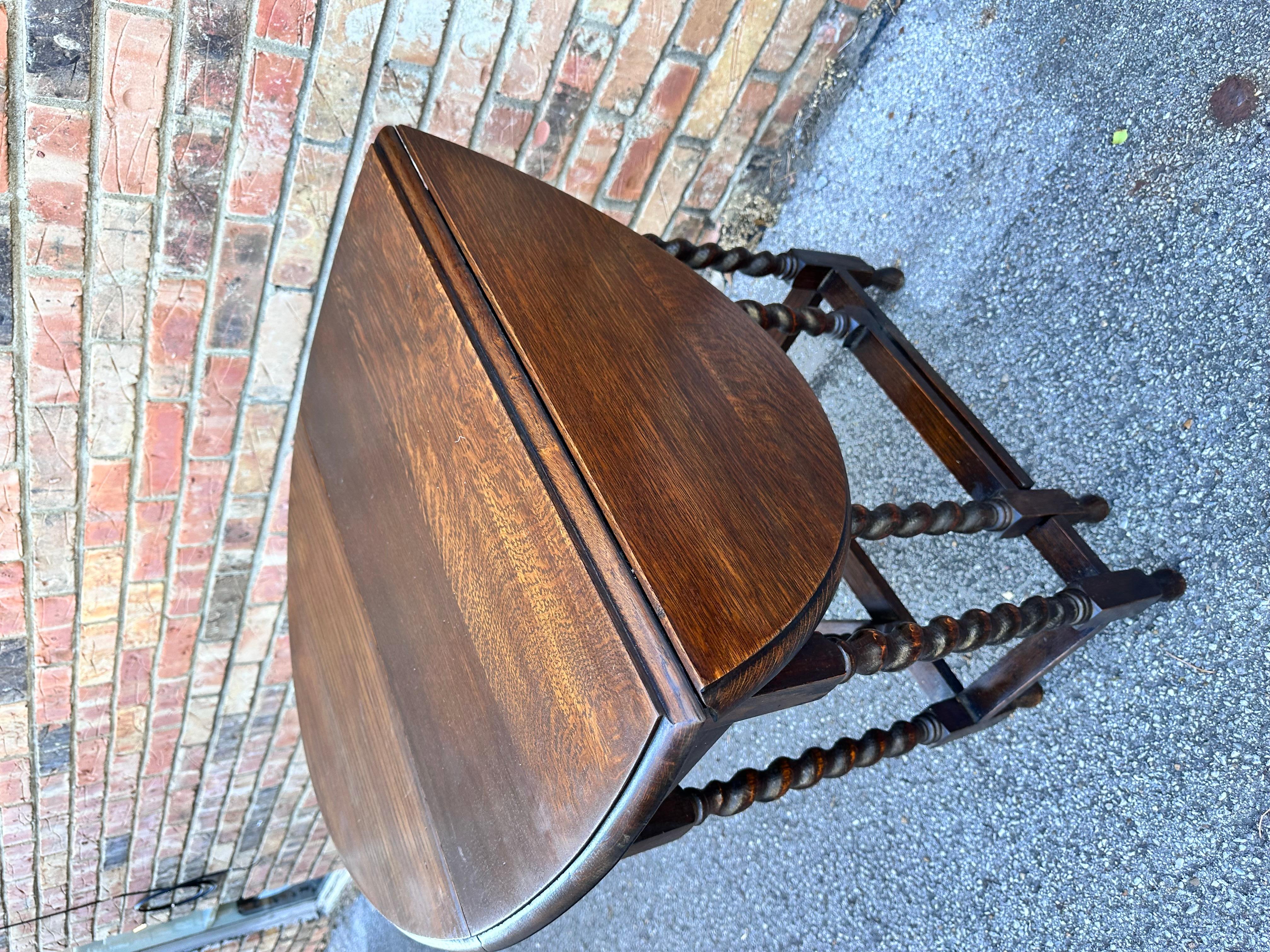 These 19th century antique English barley twist table are stunning! The table is made from oak and has a lovely dark finish and beautiful patina. The turned, spiral legs add the perfect touch of elegance, and the gate leg design allows the table to