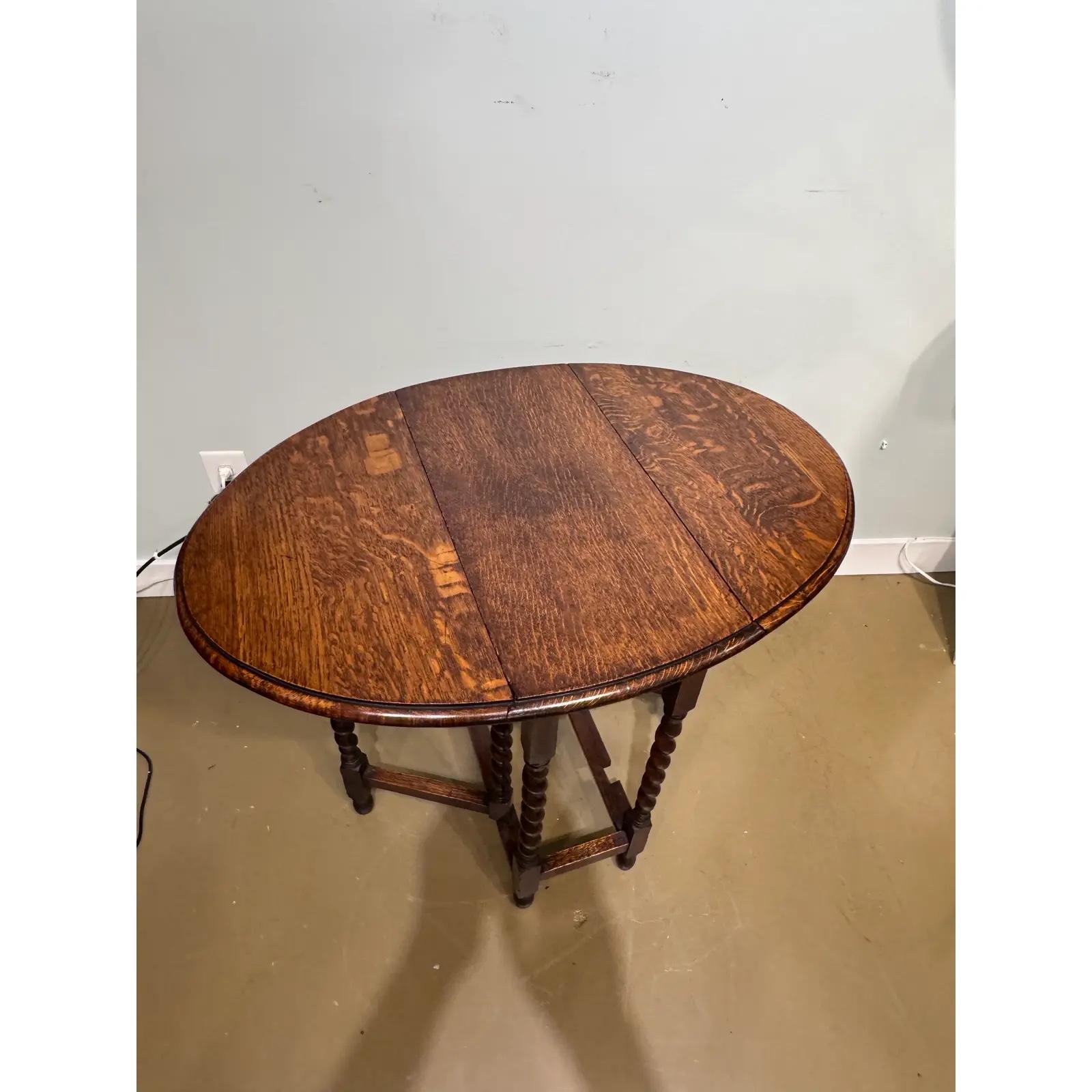 Gorgeous 19th century antique English barley twist table! The table is made from oak and has a lovely dark finish and beautiful patina. The turned, spiral legs add the perfect touch of elegance, and the gate leg design allows the table to be round
