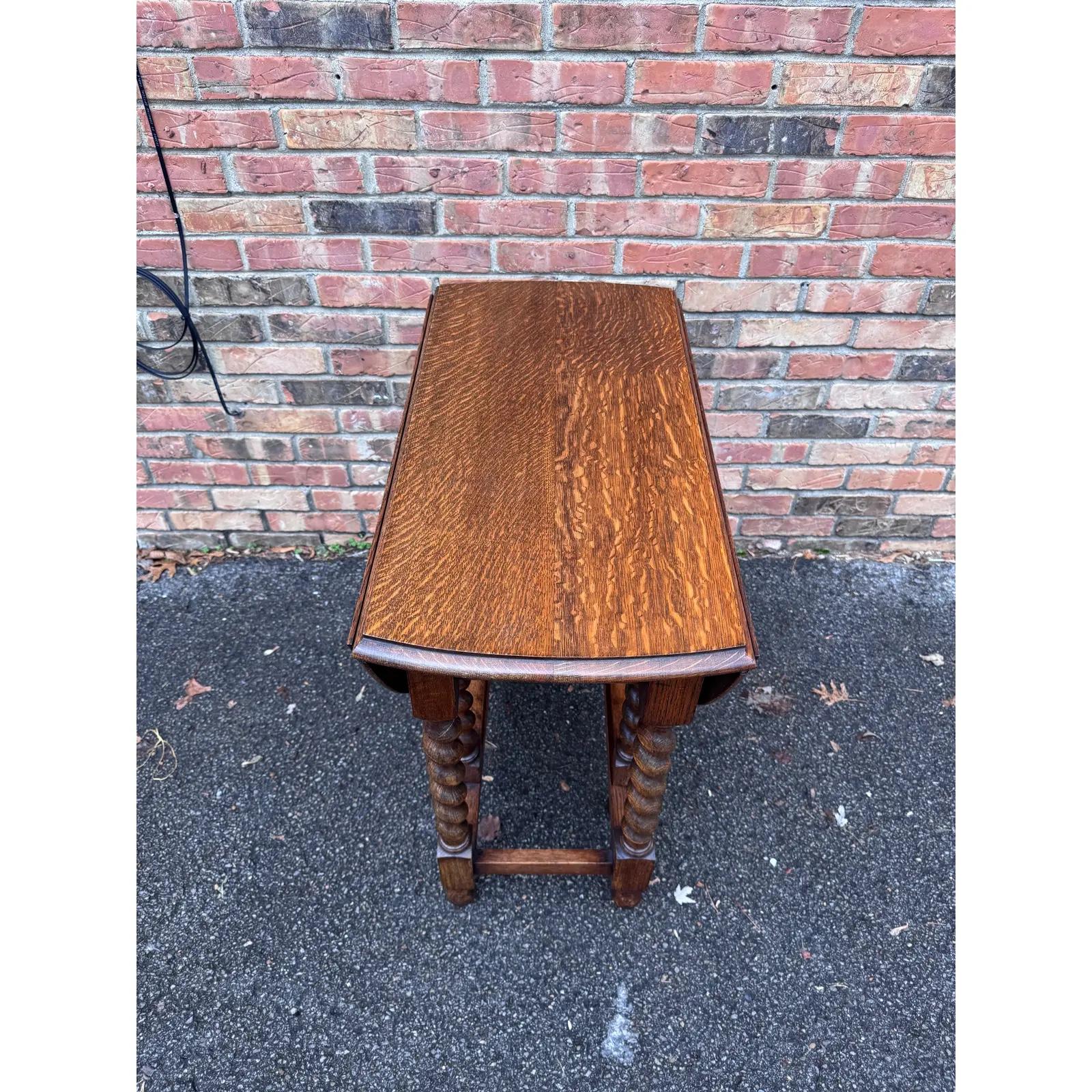 Gorgeous 19th century antique English barley twist table! The table is made from oak and has a lovely dark finish and beautiful patina. The turned, spiral legs add the perfect touch of elegance, and the gate leg design allows the table to be round