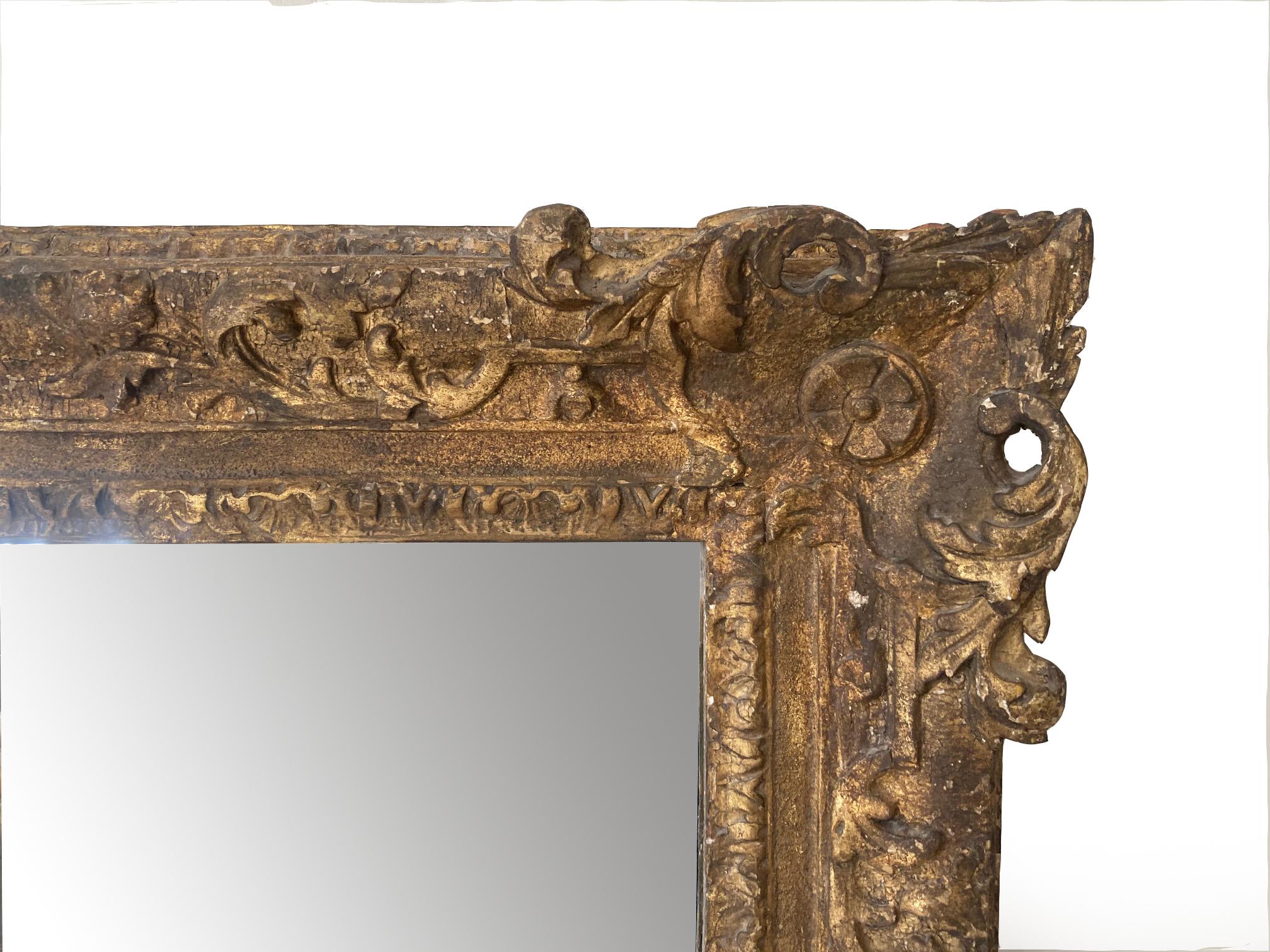 This one-of-a-kind mirror was constructed from a George I frame, circa 1720, with mirror glass installed, making it a beautiful choice for an over-the-mantle mirror. It is carved wood and of the type attributed to Lely. I simply added a mirror plate