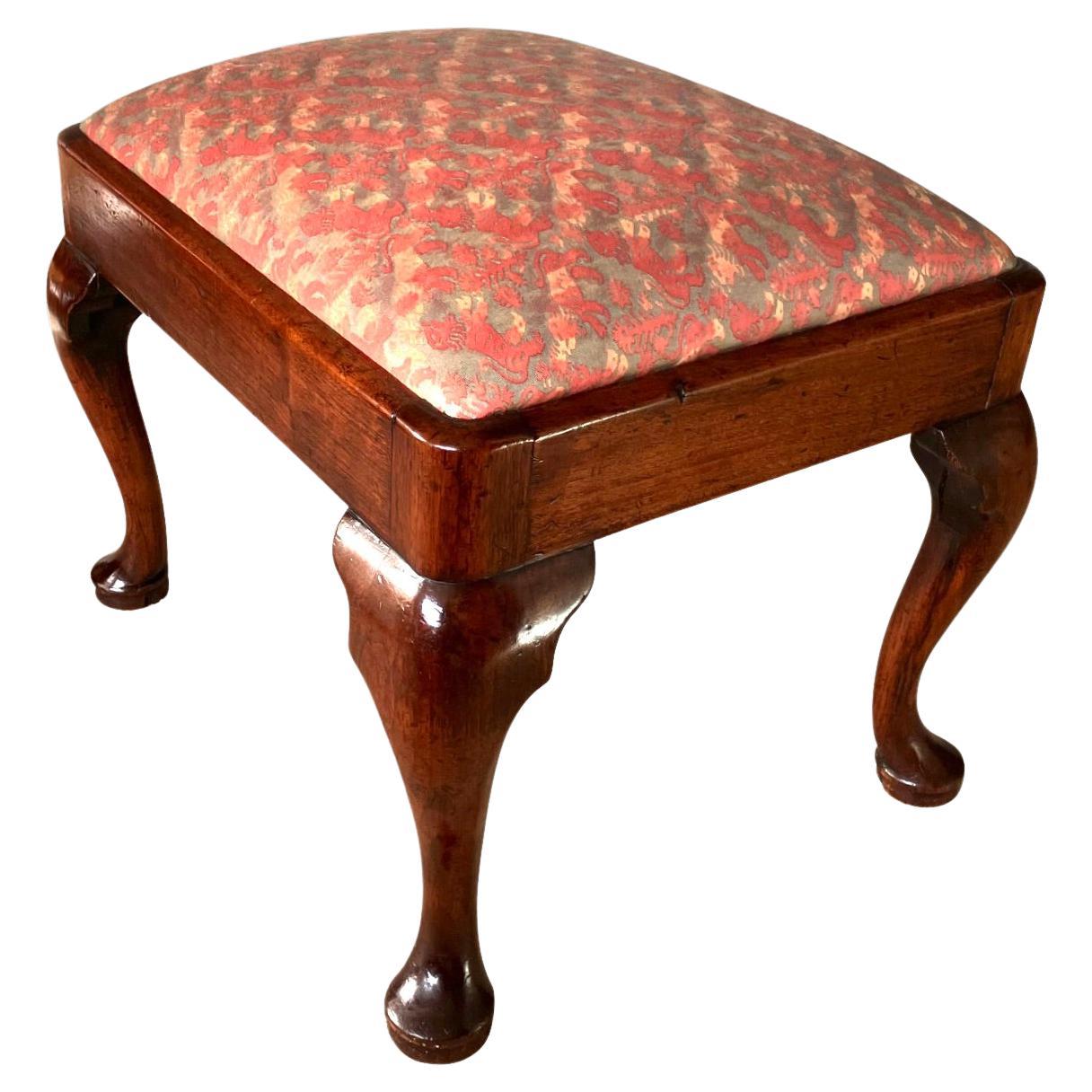 An elegant English George I period mahogany small bench or stool, the cushion inset in a rectangular frame, now upholstered in Fortuny silk, resting on cabriole legs ending in pad feet. Attractive warm nutty brown color. Circa 1730-1750.