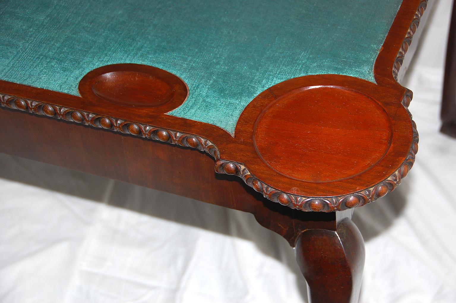 English George II Chippendale period mahogany card table with ridged cabriole legs, carved ball and claw feet, modified egg and dart molding. The turret corners are dished for candlesticks, there are also oval 