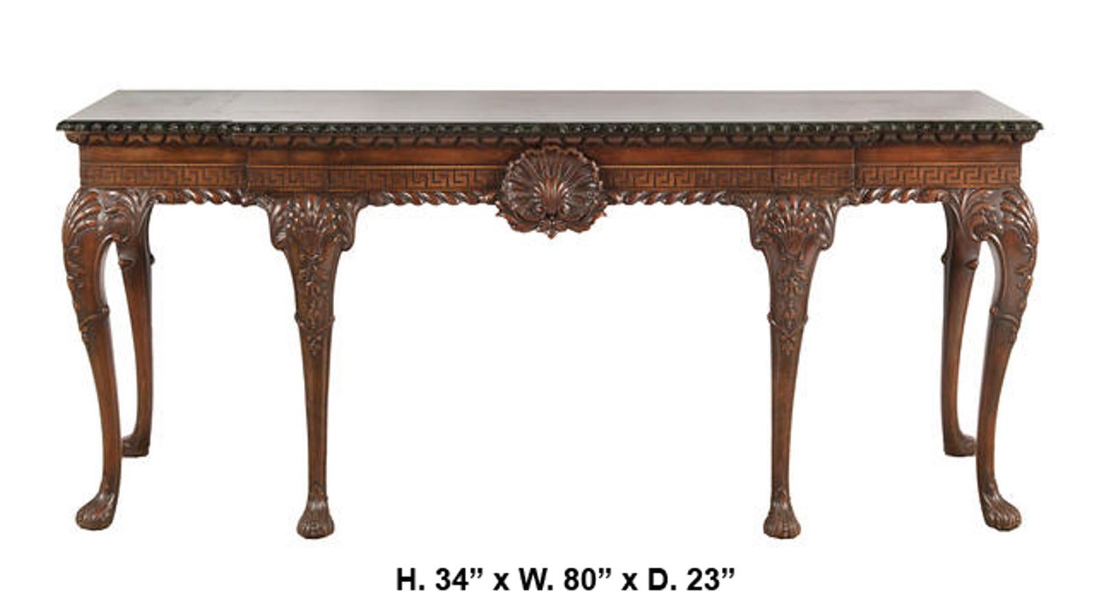 Imposing 19th century English George II style carved mahogany console.
Moulded large green marble top over a conforming breakfront frieze fitted with three drawers decorated with Greek Key and centered by a finely hand carved ornamental shell,
