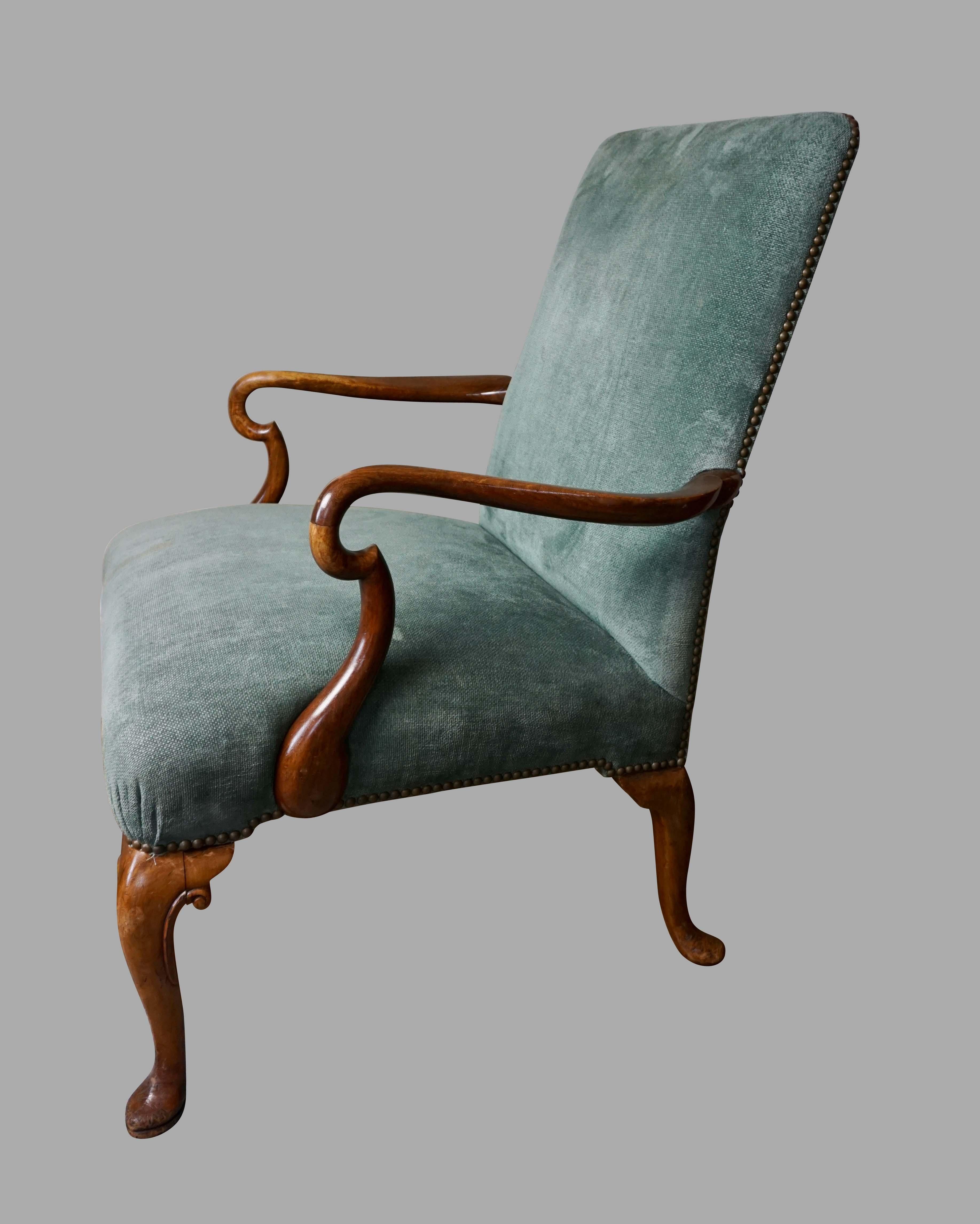 A handsome and substantial English Georgian style open armchair with shepherd's crook arms supported on scrolled cabriole legs ending in slipper feet. Now upholstered in blue-grey fabric finished with nailhead trim. A comfortable and elegant