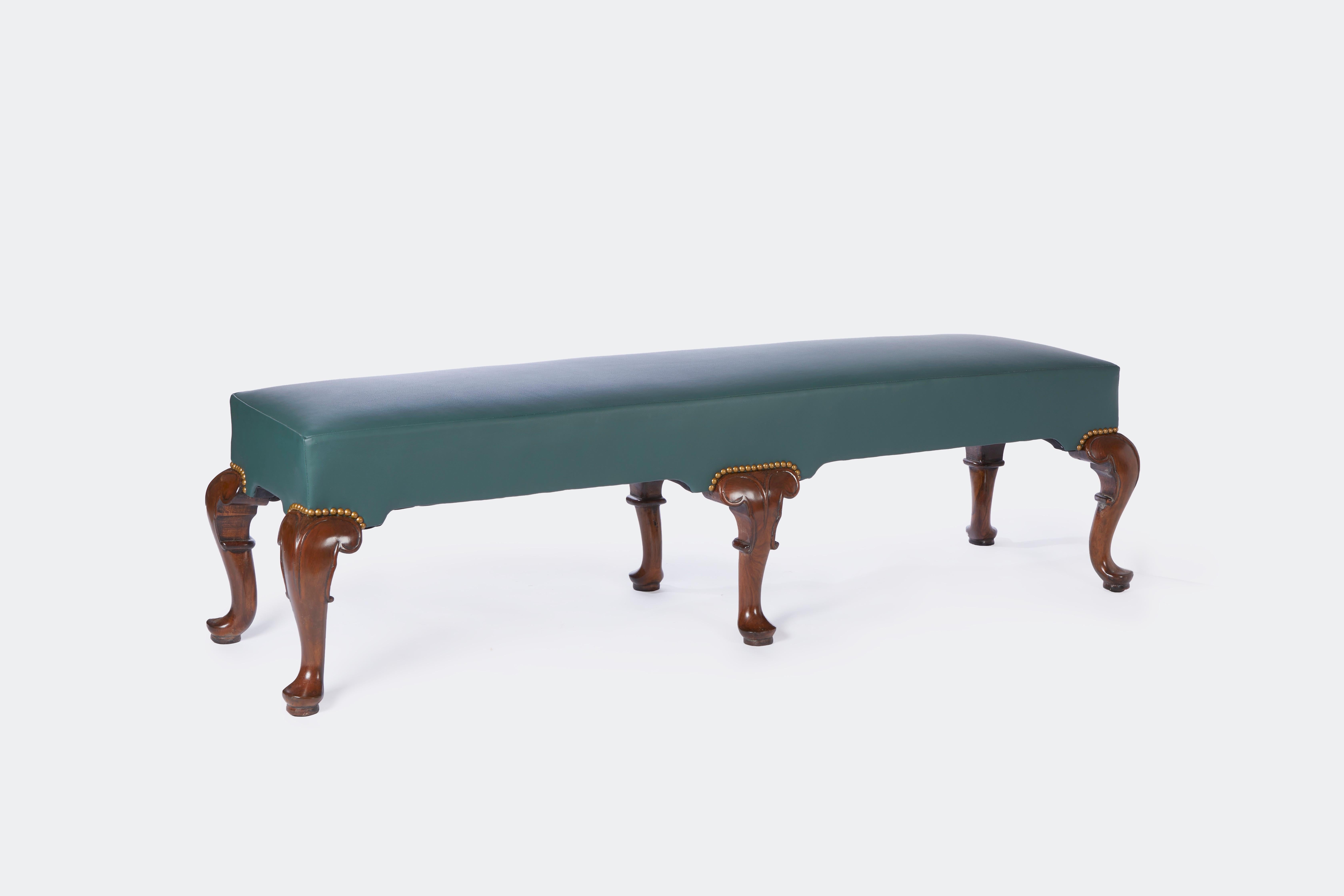English George II style long bench with 6 hand-carved cabriole form legs terminating in pad feet shaped apron finished on four sides and having nail head trim detail bench circa 1870.
Provenance: A Perish-Hadley interior Henryck de Kwiatkowski.