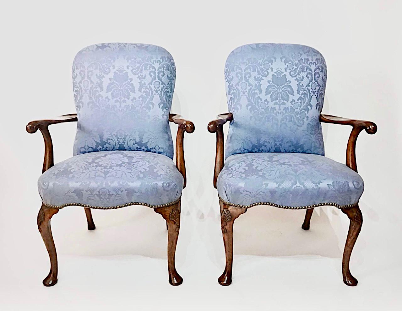 An exceptional and exceptionally rare set of 10, circa 1735, English George II period, walnut dining chairs consisting of 2 armchairs and 8 side chairs, the upholstered 'waisted' or 'compassed' upholstered backs, the armchairs with out-scrolled