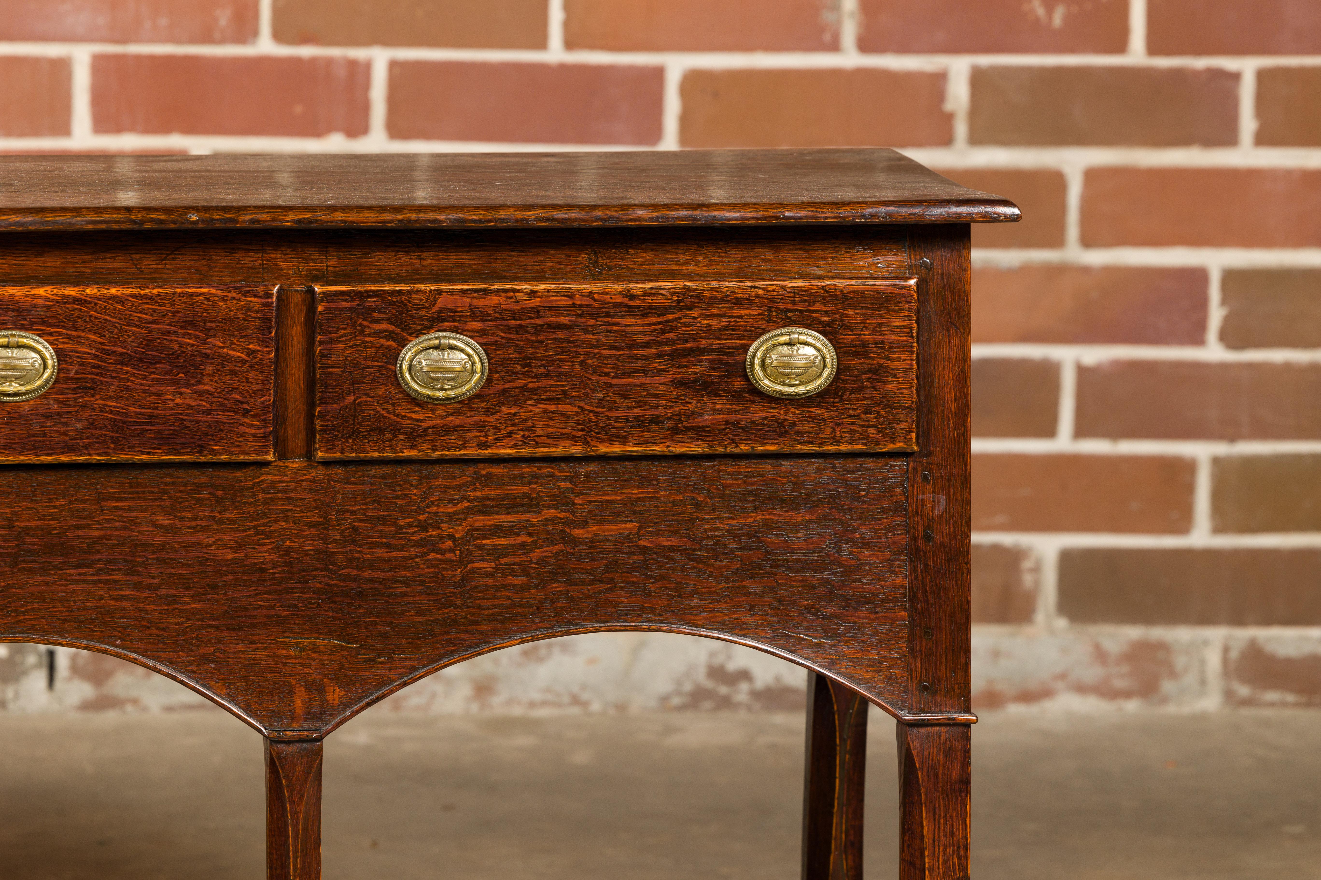 Brass English George III 1800s Oak Dresser Base with Three Drawers and Arching Accents For Sale