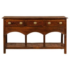 Antique English George III 1800s Oak Dresser Base with Three Drawers and Arching Accents