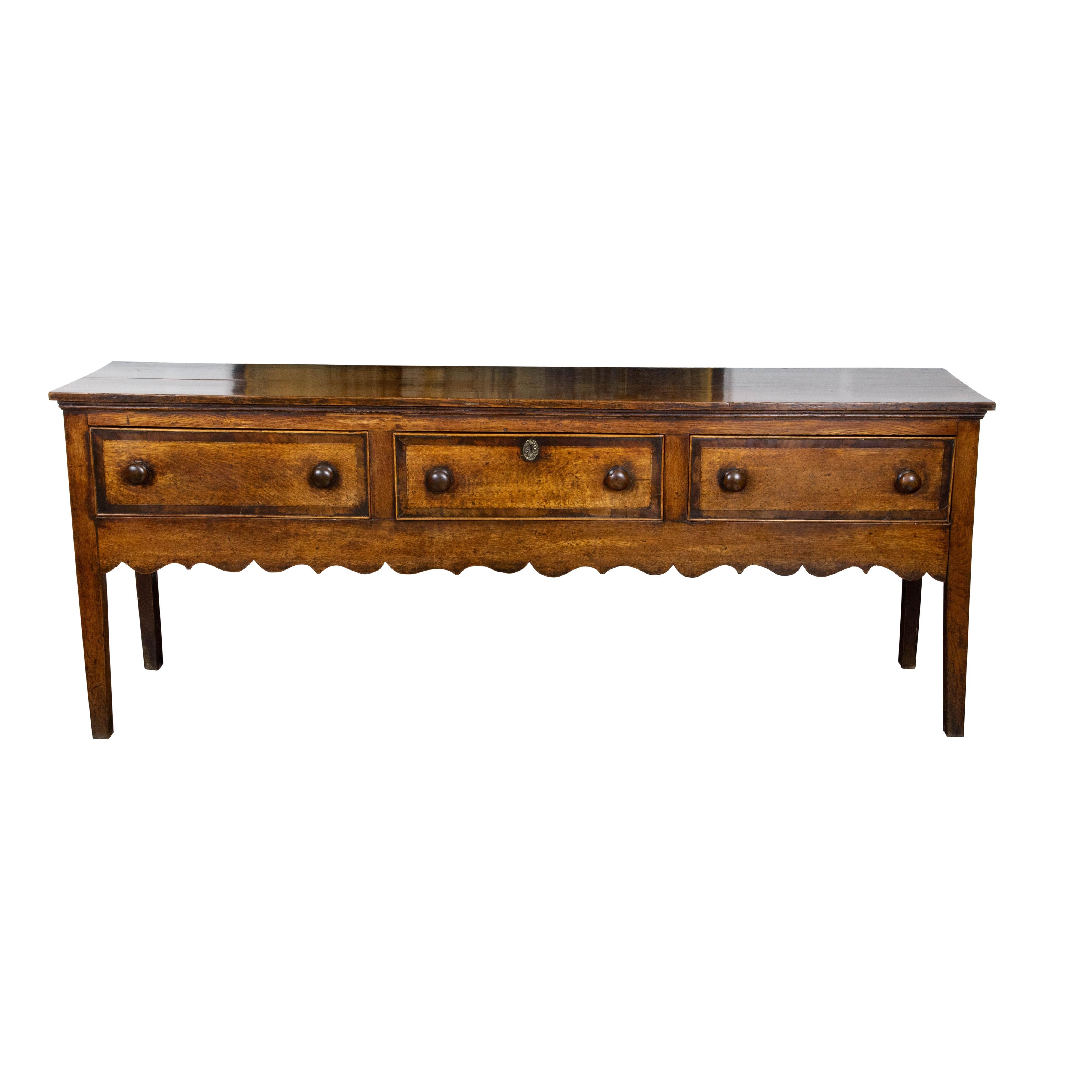 Carved English George III 1800s Oak Dresser Base with Three Drawers and Scalloped Apron