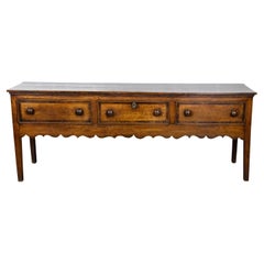 English George III 1800s Oak Dresser Base with Three Drawers and Scalloped Apron
