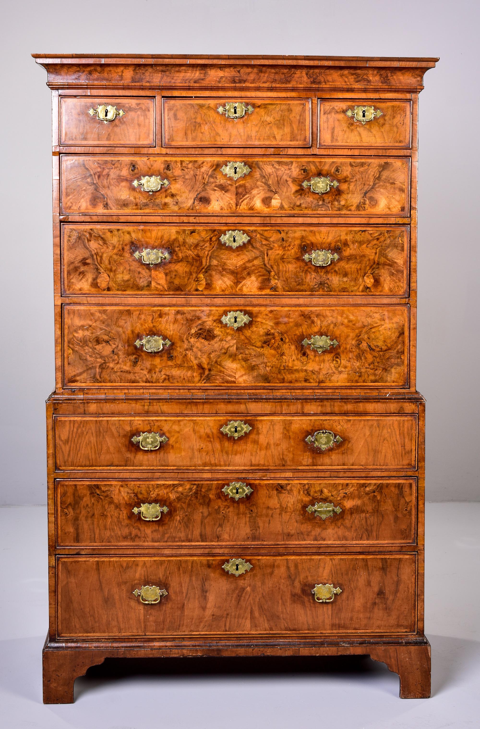 Circa 1780s George III chest on chest in burl walnut with original brass hardware. Tall, handsome chest shows authentic age and stands nearly seven feet high. Some cracks to veneer on sides and drawer bottoms - see detail photos. Some scattered