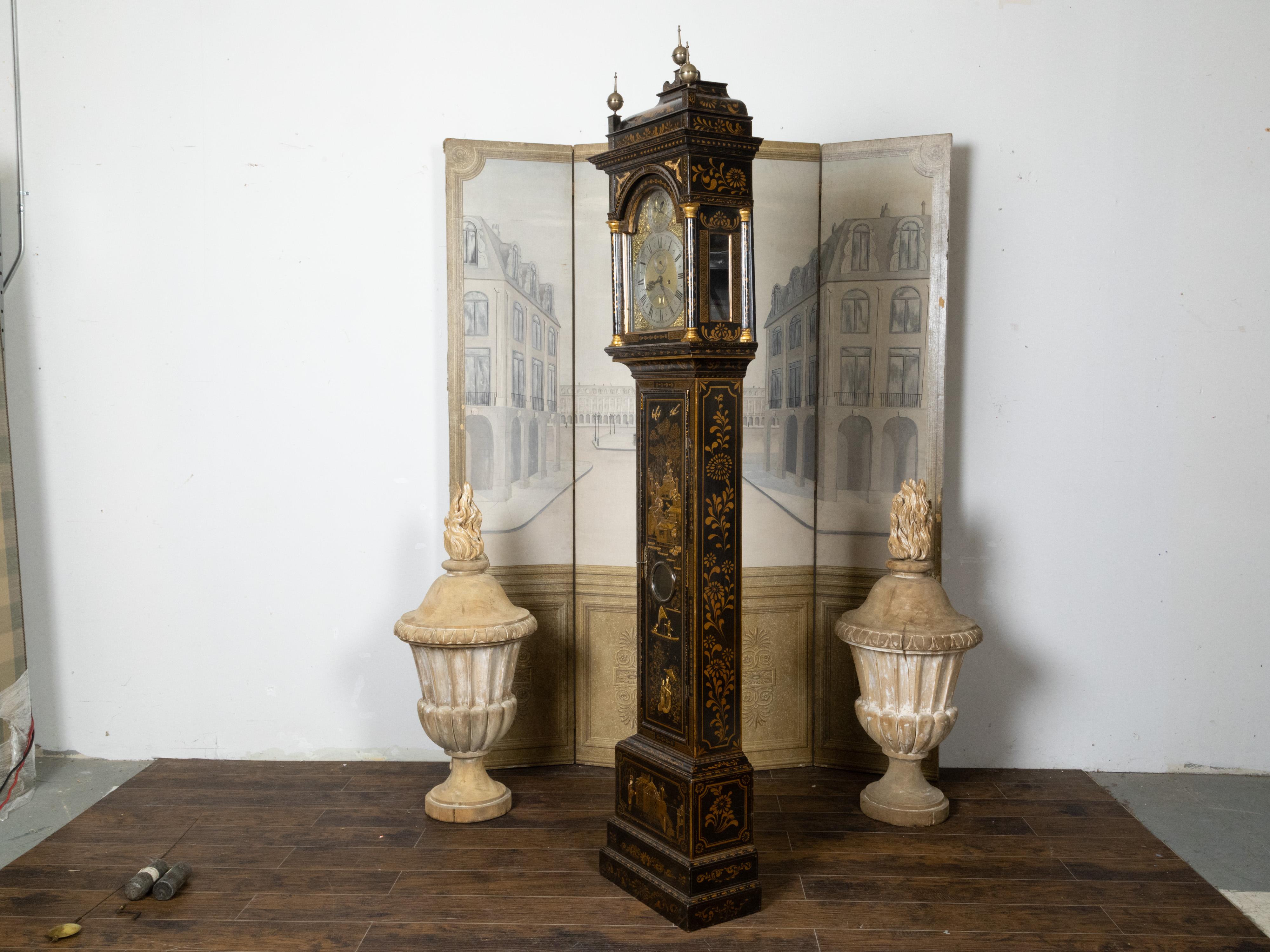 An English George III period Chinoiserie parcel gilt and japanned tall case clock from the 18th century, with black paint and arched brass dial. Created in England during the reign of king George III, this tall case clock features a slender