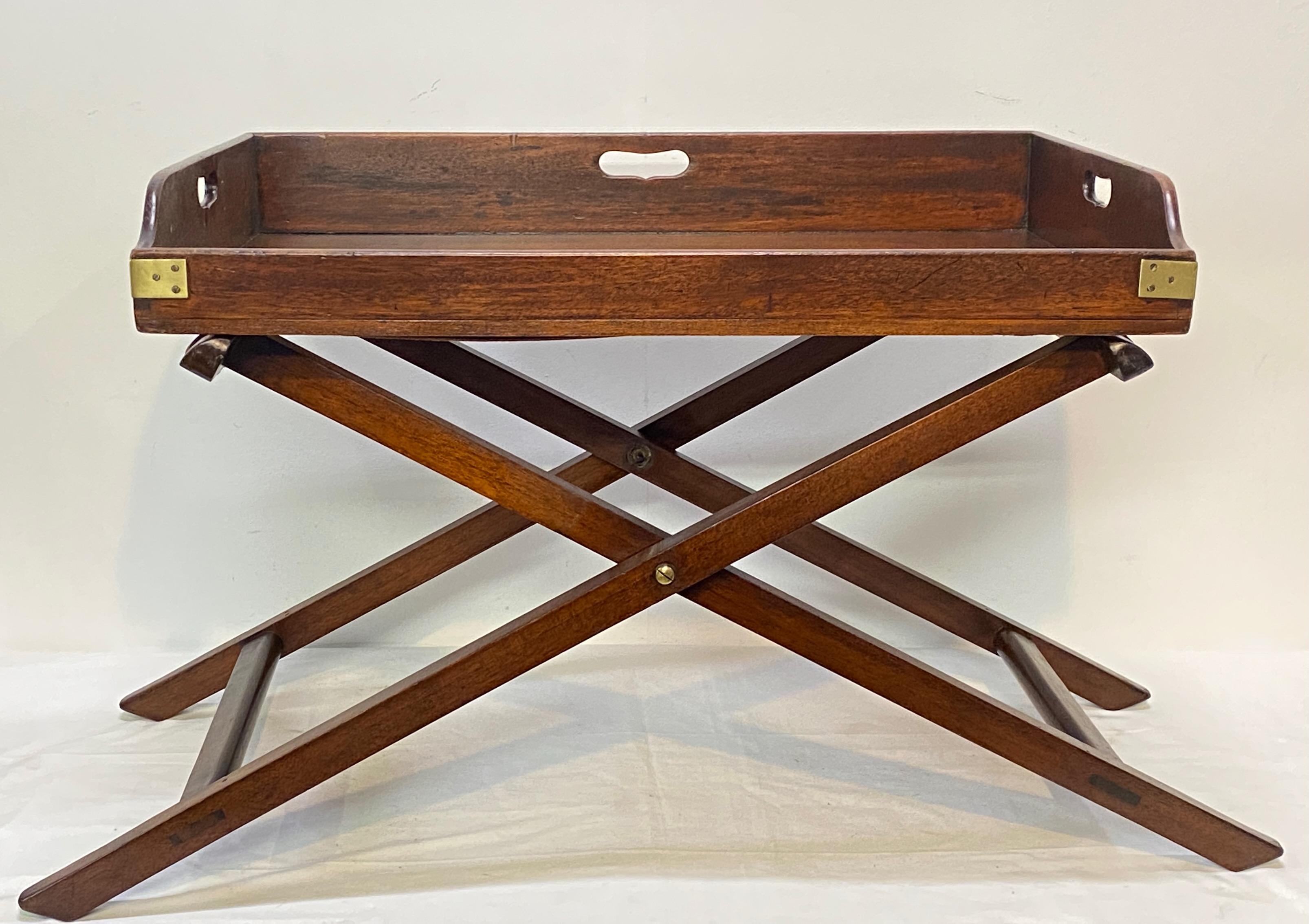 Traditional George III period mahogany butler's serving tray with brass corners on a later custom made stand. 
Beautiful antique condition. 
England, early 19th century.