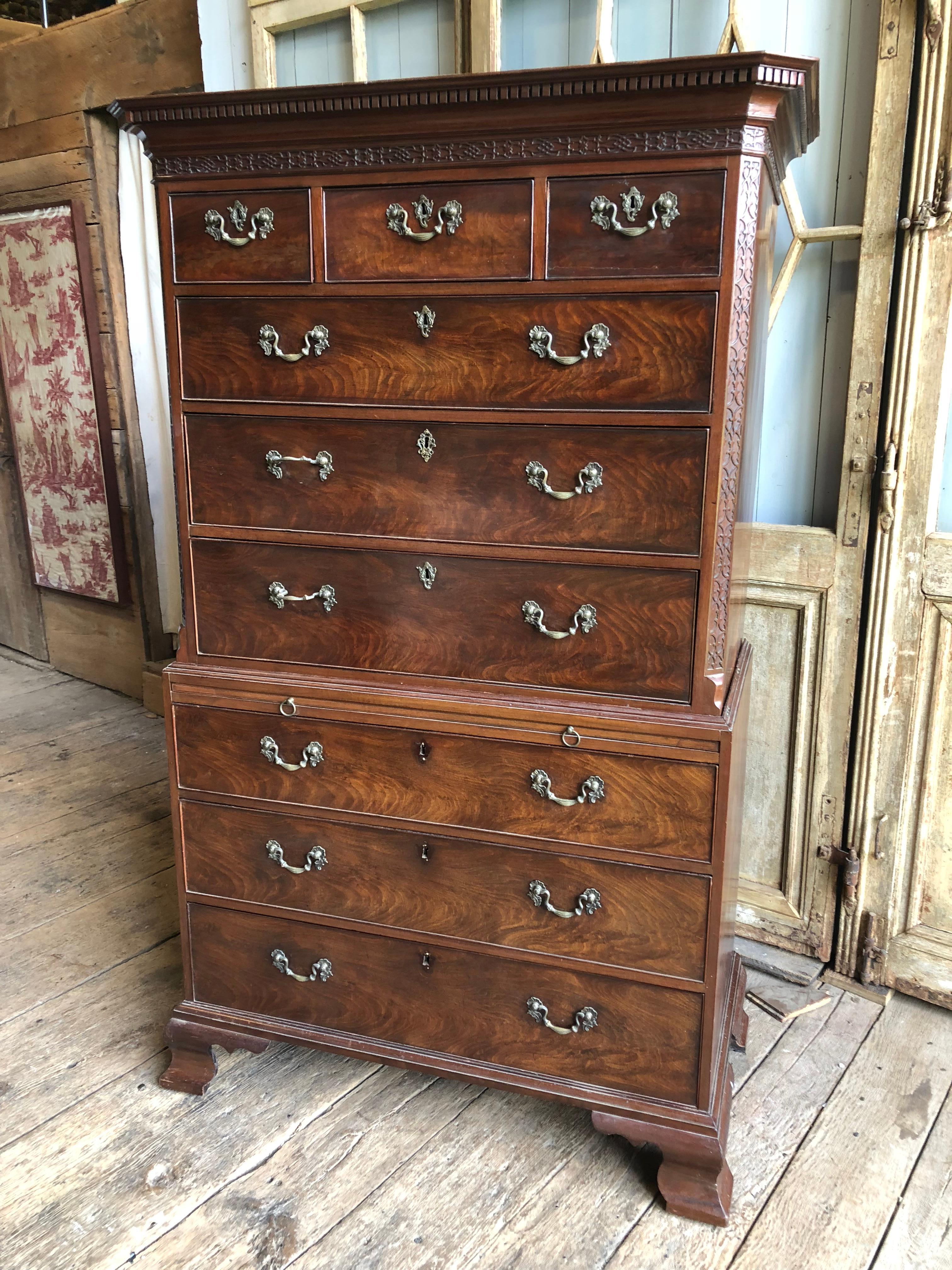 A fine English George III chest-on-chest highboy in mahogany with a dentil cornice and lattice decoration over three short drawers and three full-length drawers in the upper cabinet, the lower cabinet having a pull-out candle board over three full