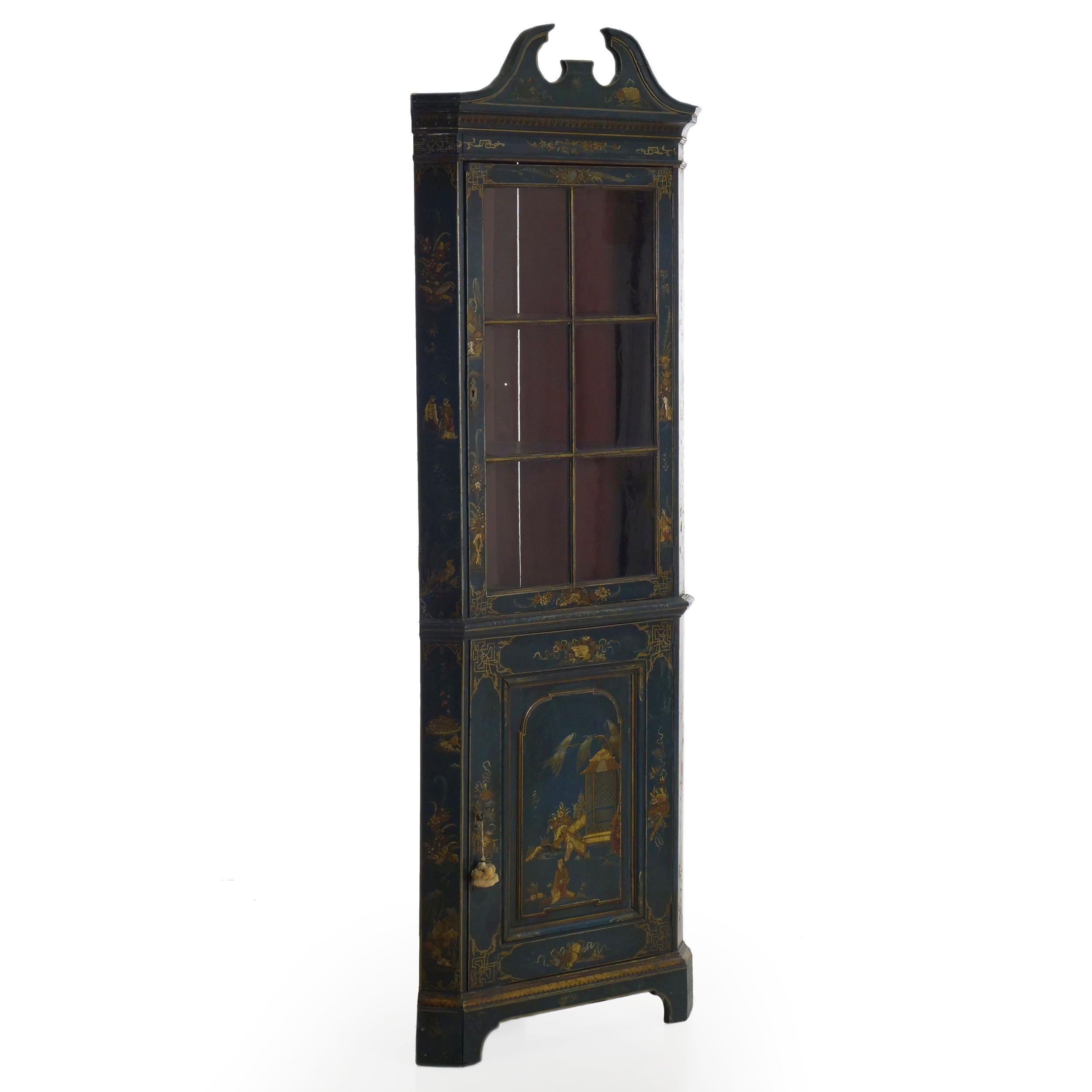 A special piece for its restrained dimensions and exquisite surface decorations throughout, this Fine George III corner cabinet exhibits an overall blue painted surface highlighted by embossed and stenciled 