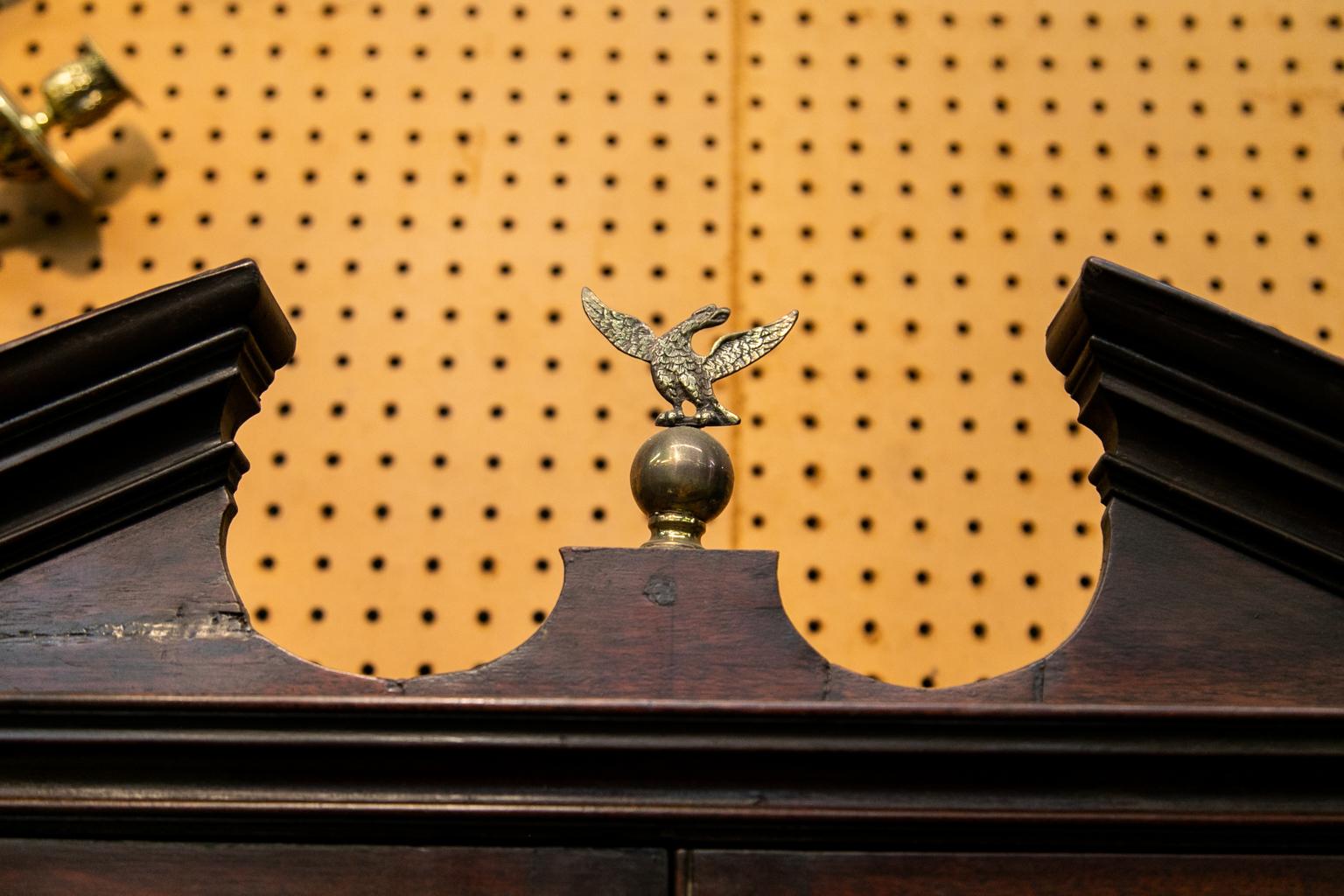 This English George III hanging wall cabinet has raised panel doors with a beaded center astragal on the right hand door. The door has a working lock and key. All hardware, except for the four hinges and the left hand sliding door locks, are later.