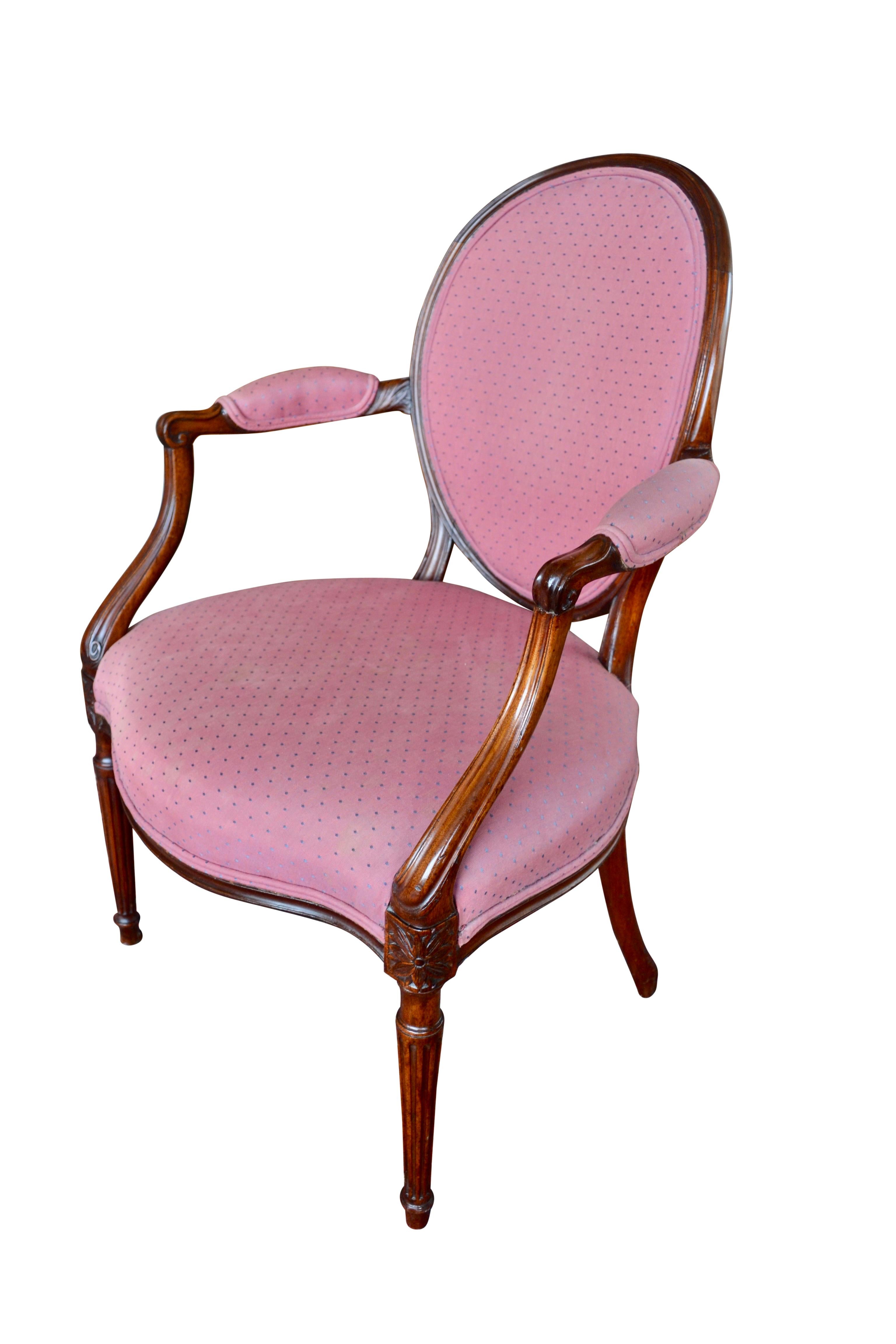 An elegant period George III Hepplewhite style oval-backed armchair of well carved solid mahogany.