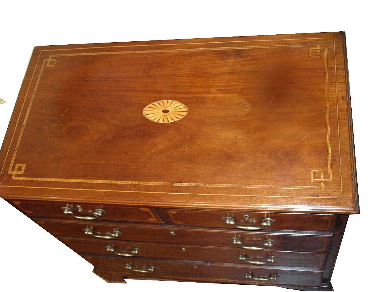  English Mahogany Five Drawer Chest,  the top inlaid with a shaded fan and banded with ebony bees wing and boxwood inlay. The drawers have quarter shell fans and are also banded with boxwood, ebony, and satinwood.  It has original bracket feet and