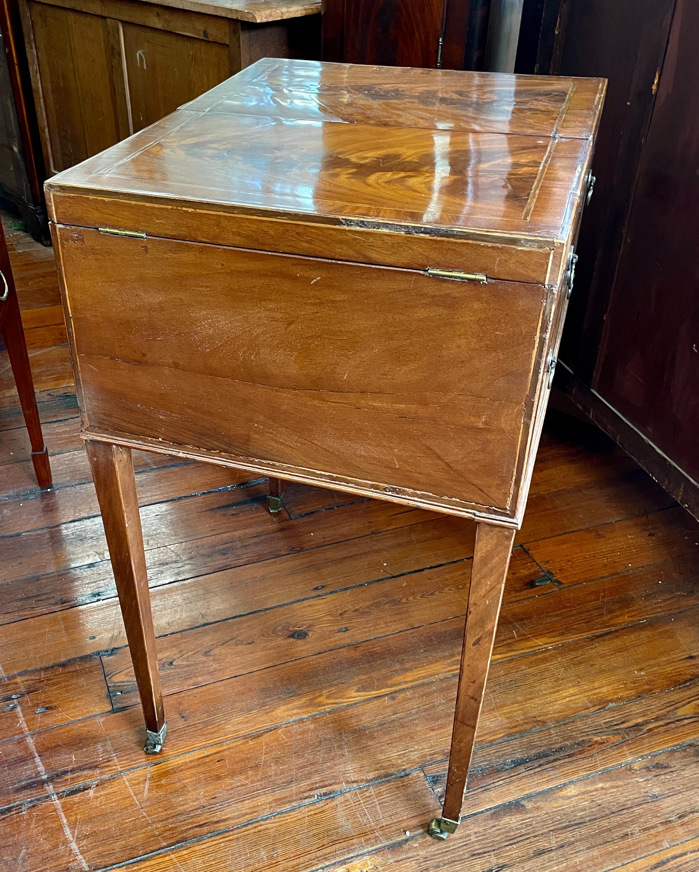 Fabulous quality rare and important antique English George III inlaid flame mahogany Gentleman's Dressing Table or Beau Brummel. 
This table comes with an exceptionally well fitted interior with the carved bone knobs; original ratchet adjustable