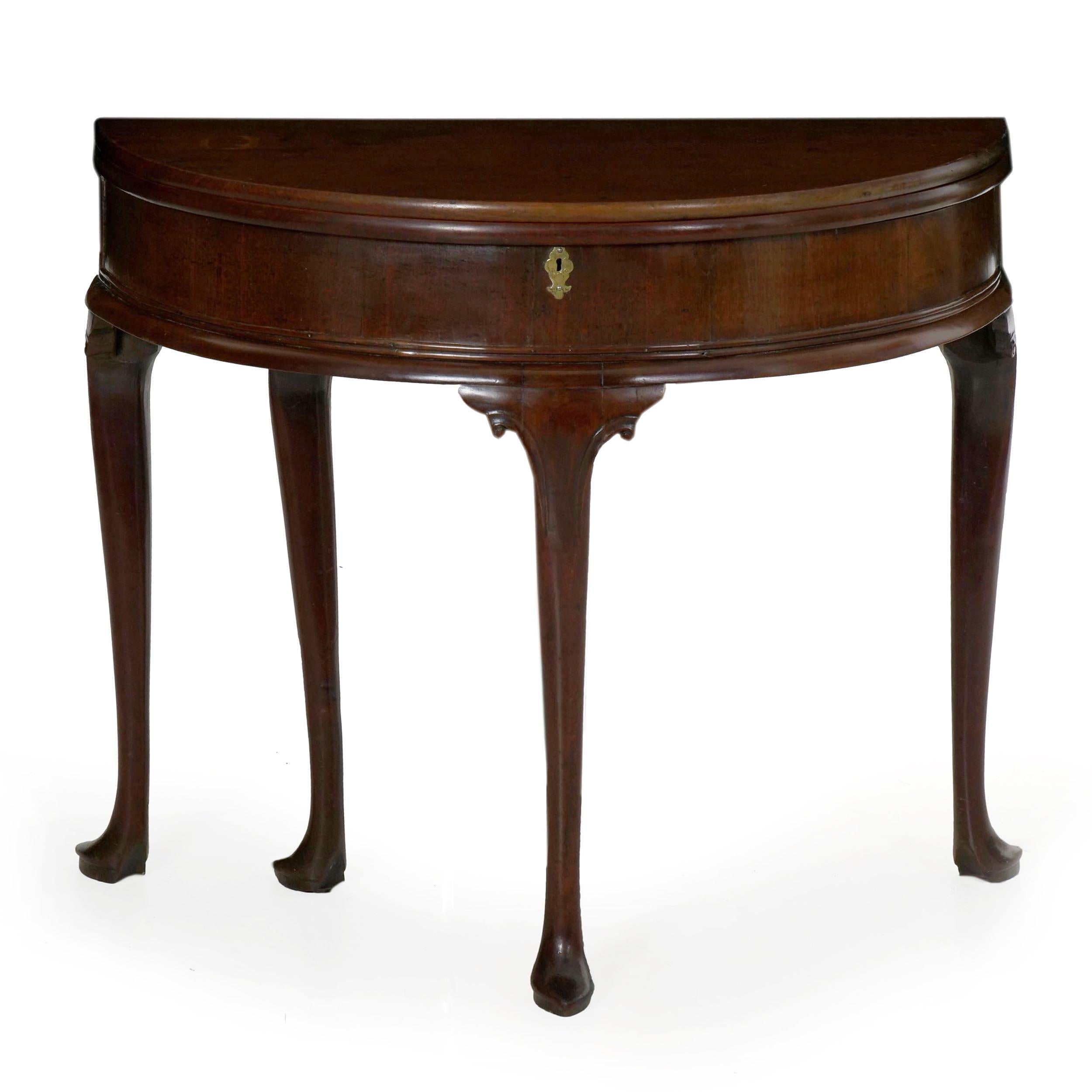This fine untouched gem is in every way a convenient console table - the demilune shape of the front allows it to be positioned in active hallways without fear of catching corners, while at the same time allowing it to transform into a full circular