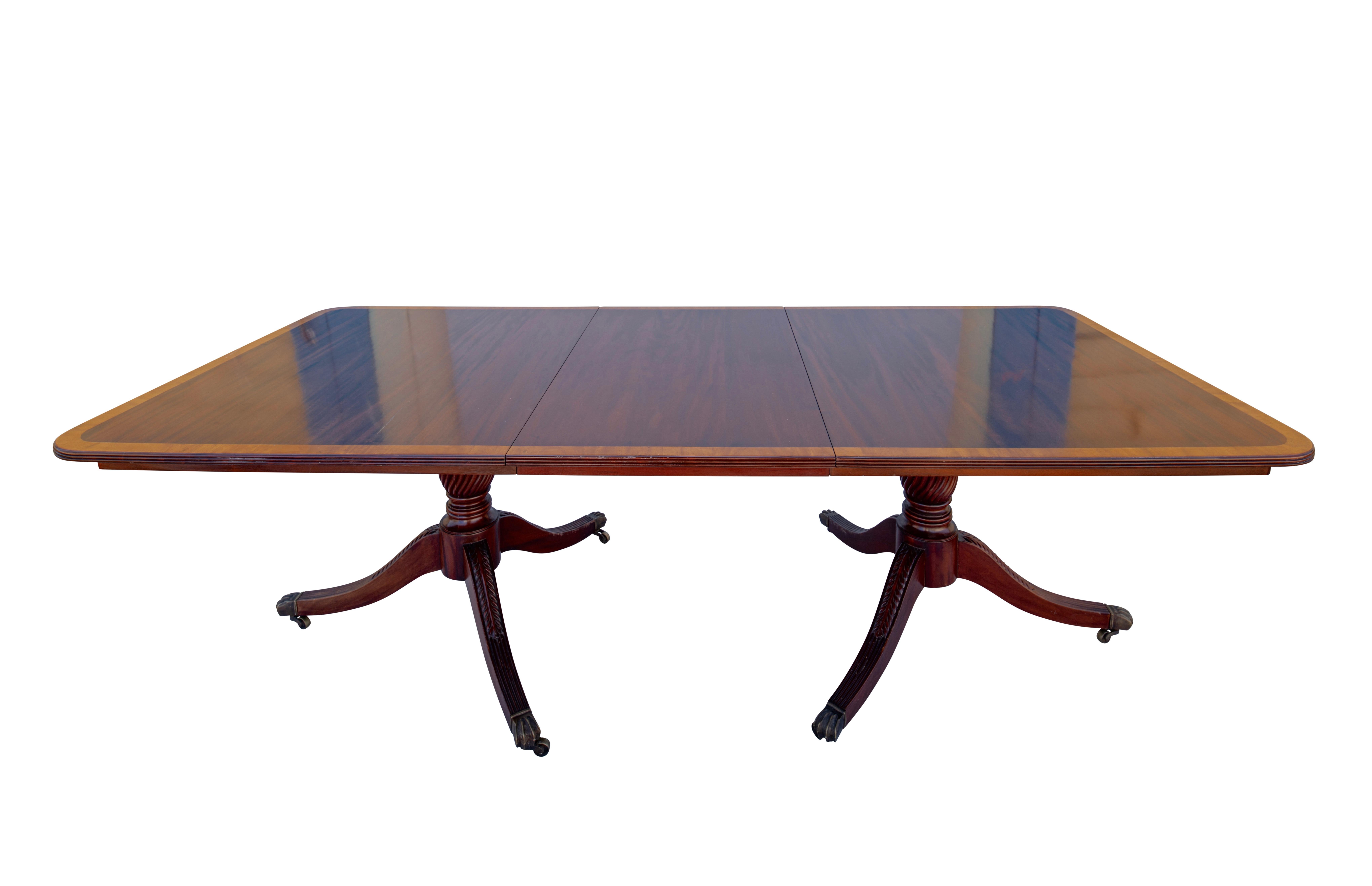 A large and unusually wide mahogany double pedestal dining table with satinwood inlay trim. The table has two leaves measuring 24 inches each. In excellent condition, professionally restored and refinished sometime in the 1970s.
England, early 19th