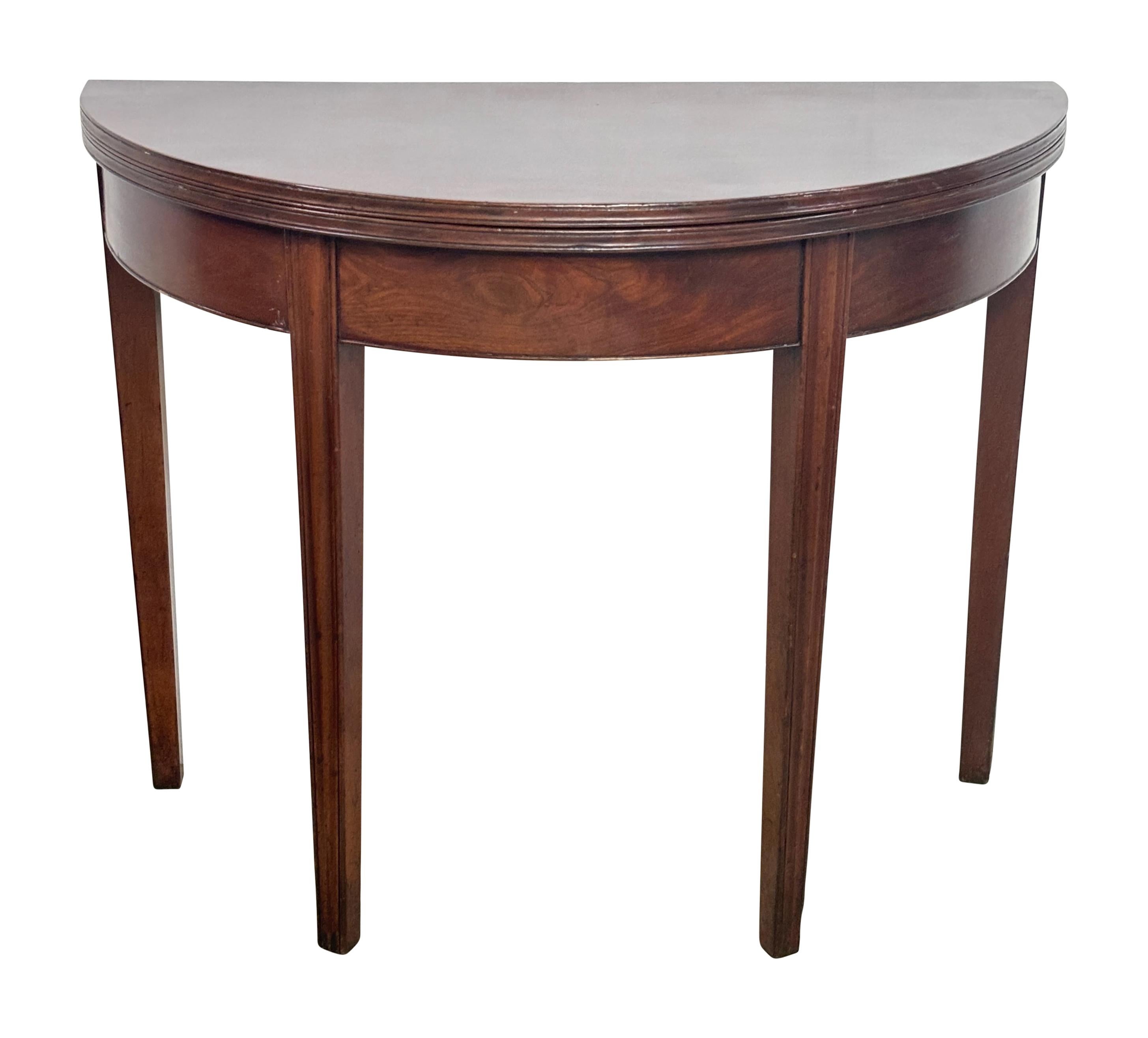 A late 18th - early 19th century mahogany English George III period game table or breakfast table. An unusual size that would be useful in a small room.
Demi-lune shape when closed, when open gate leg supports a round surface table with a 35 5/8