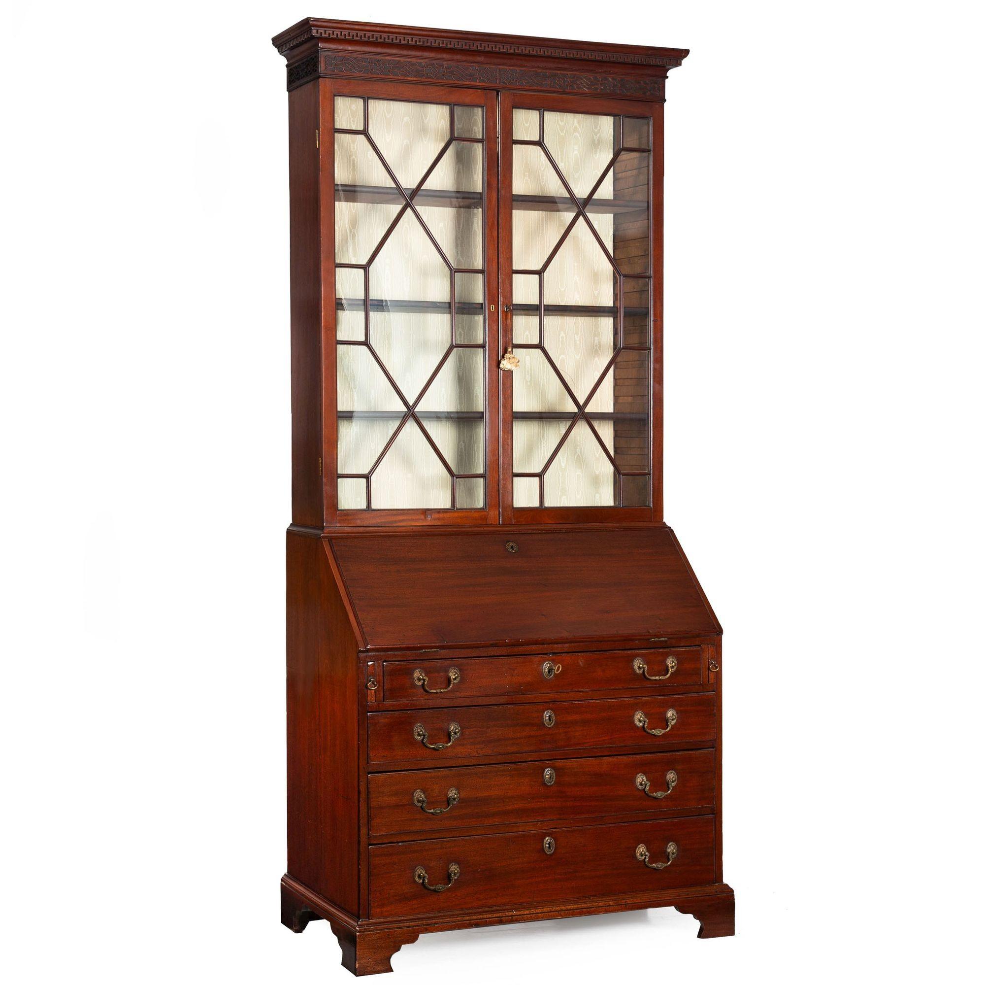 GEORGE III MAHOGANY SECRETARY DESK WITH GLAZED UPPER BOOKCASE
England, circa 1780  formerly with Ginsburg & Levy
Item # 401HYF25Q

A rich and vibrant secretary desk from the late years of the 18th century, it features a powerful molded crown in