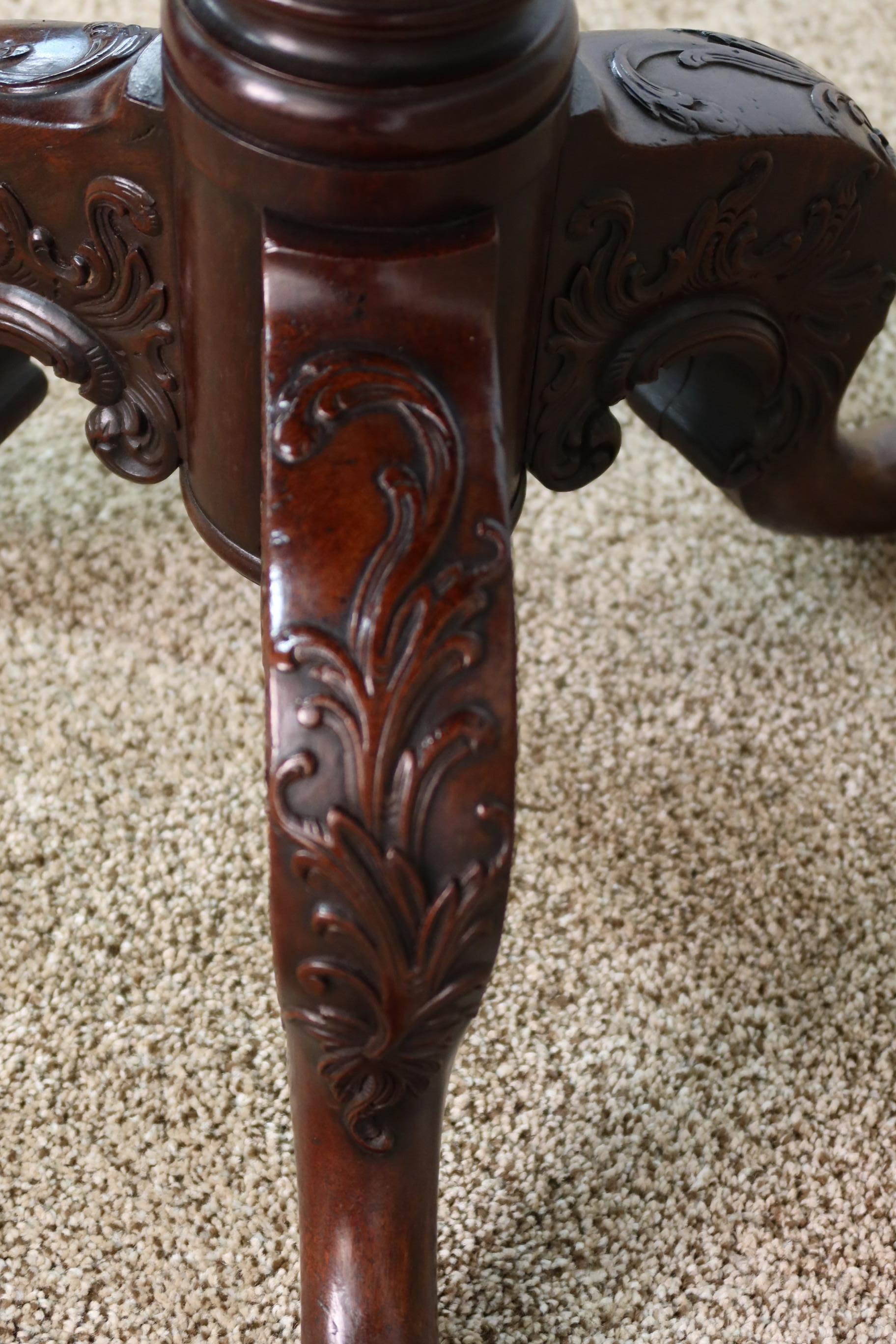 Antique English mahogany tilt-top tea table with finest quality carved base and fluted column. Split in top was restored in our workshop, circa 1780.