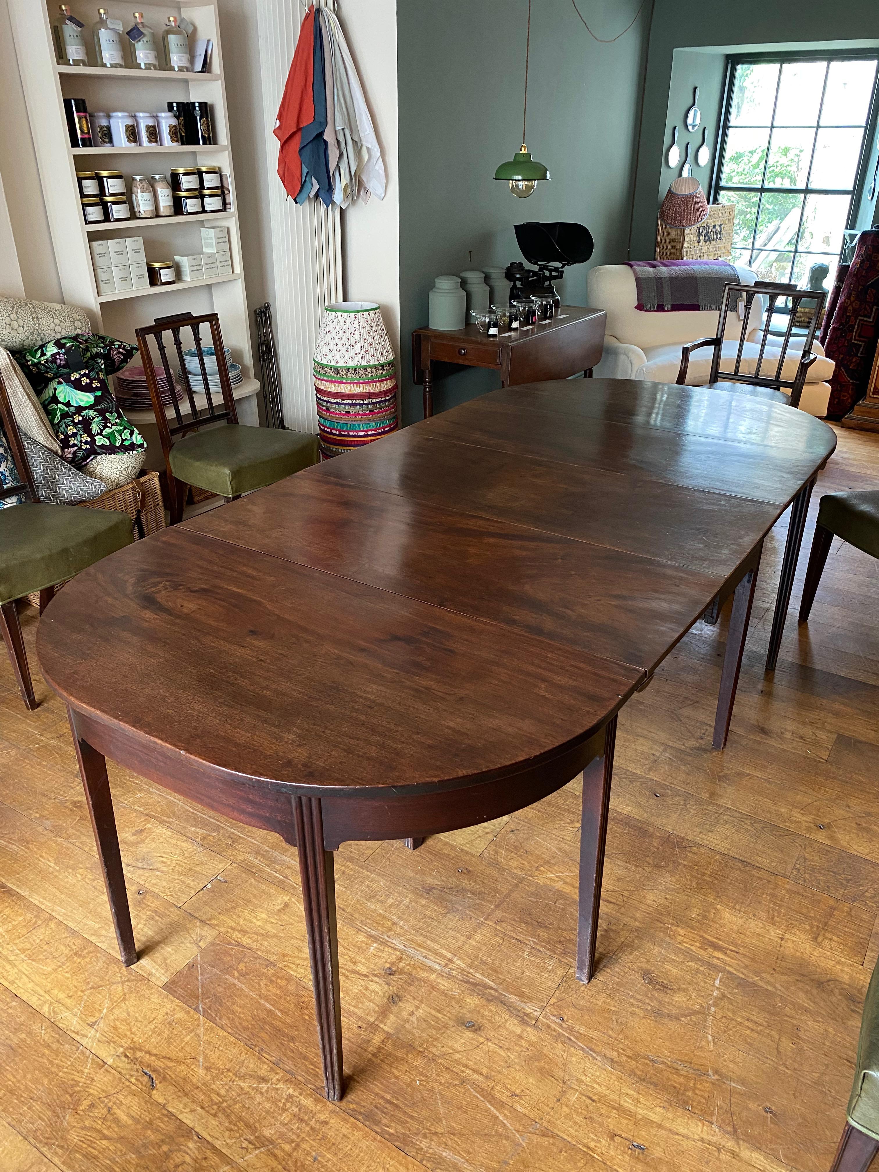 A fantastic, all original Mahogany dining table circa 1810. A robust, yet delicate feeling table sitting upon fluted legs.

This incredibly versatile piece has multiple configurations ranging from a full dining table, which can comfortably seat 6,