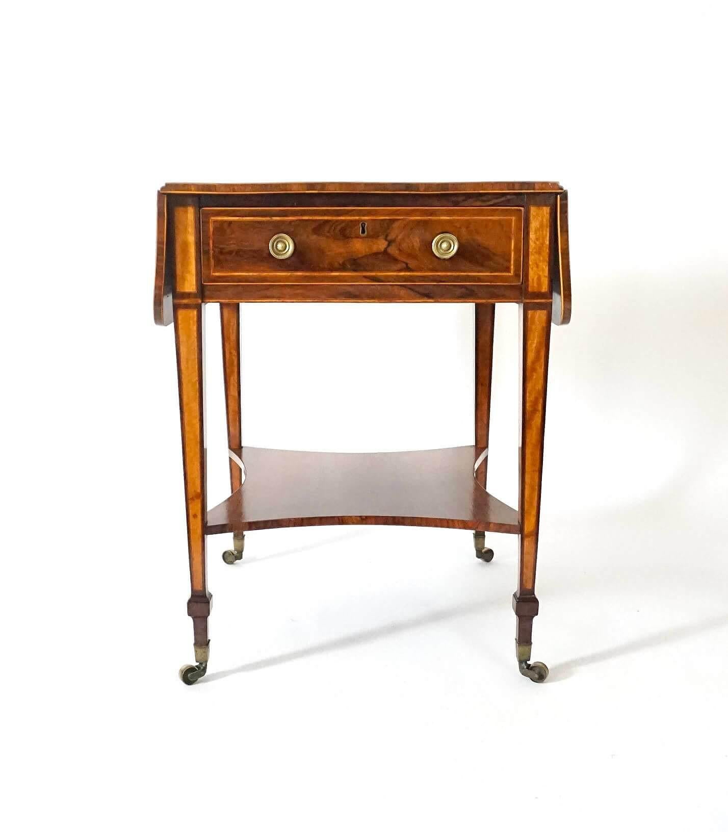 An extremely fine circa 1800 English George III period rosewood and satinwood 'Sheraton' pembroke table of rectangular double sided form, the top having drop 'D' shaped ends above full length drawer and false reverse-side all with finely cast brass