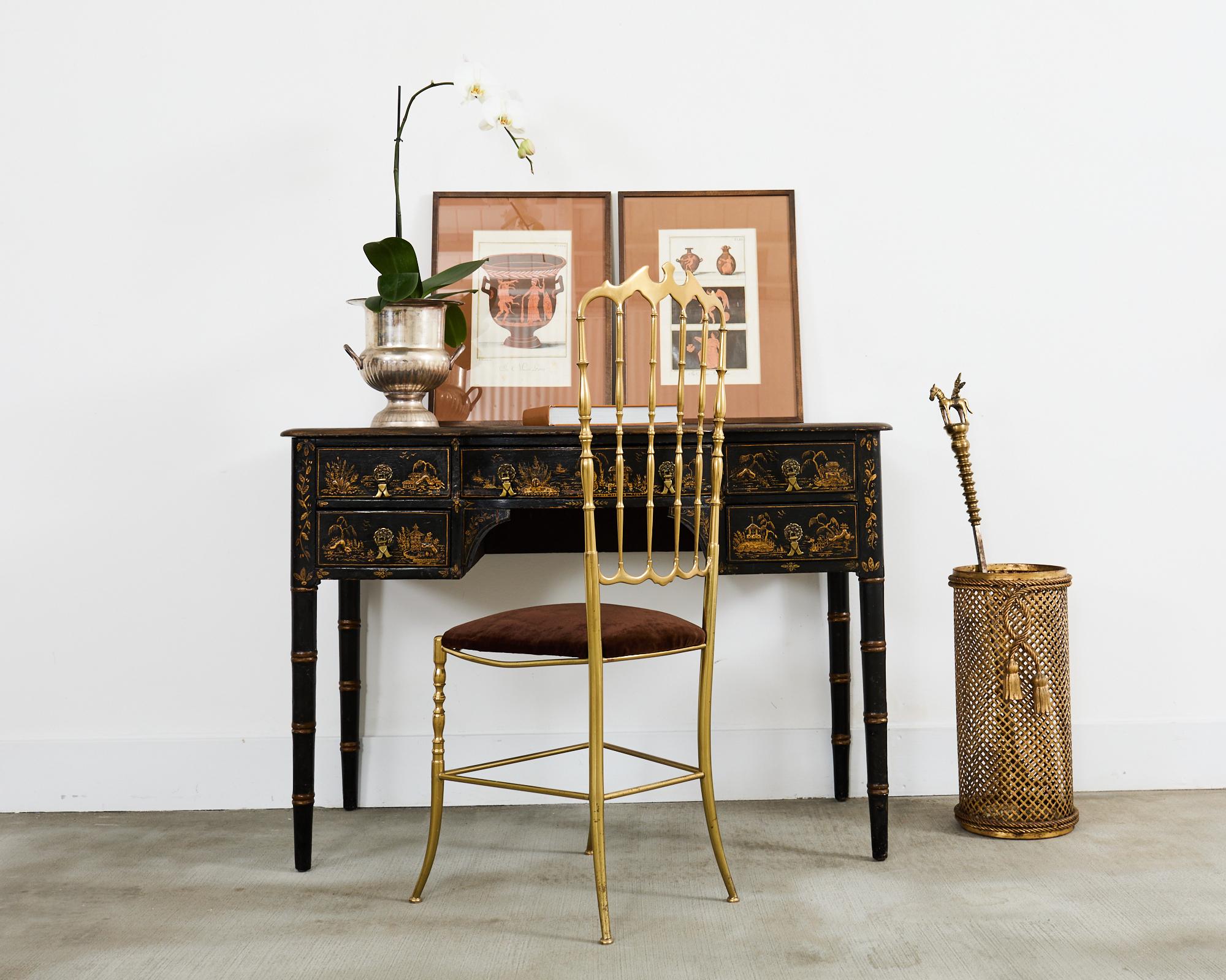 Opulent 19th century English George III style writing table or desk decorated in the chinoiserie revival period of late 19th century to early 20th century Europe. The desk features a knee hole style case with a bowed front. The desk is supported by