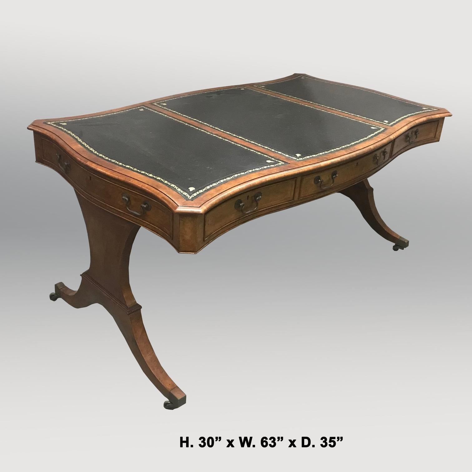 Uniquely shaped English George III style mahogany serpentine desk.
The moulded top of the desk is inset with three tooled leather writing surfaces, over a conforming serpentine frieze fitted with three drawers and seven sham drawers raised on two