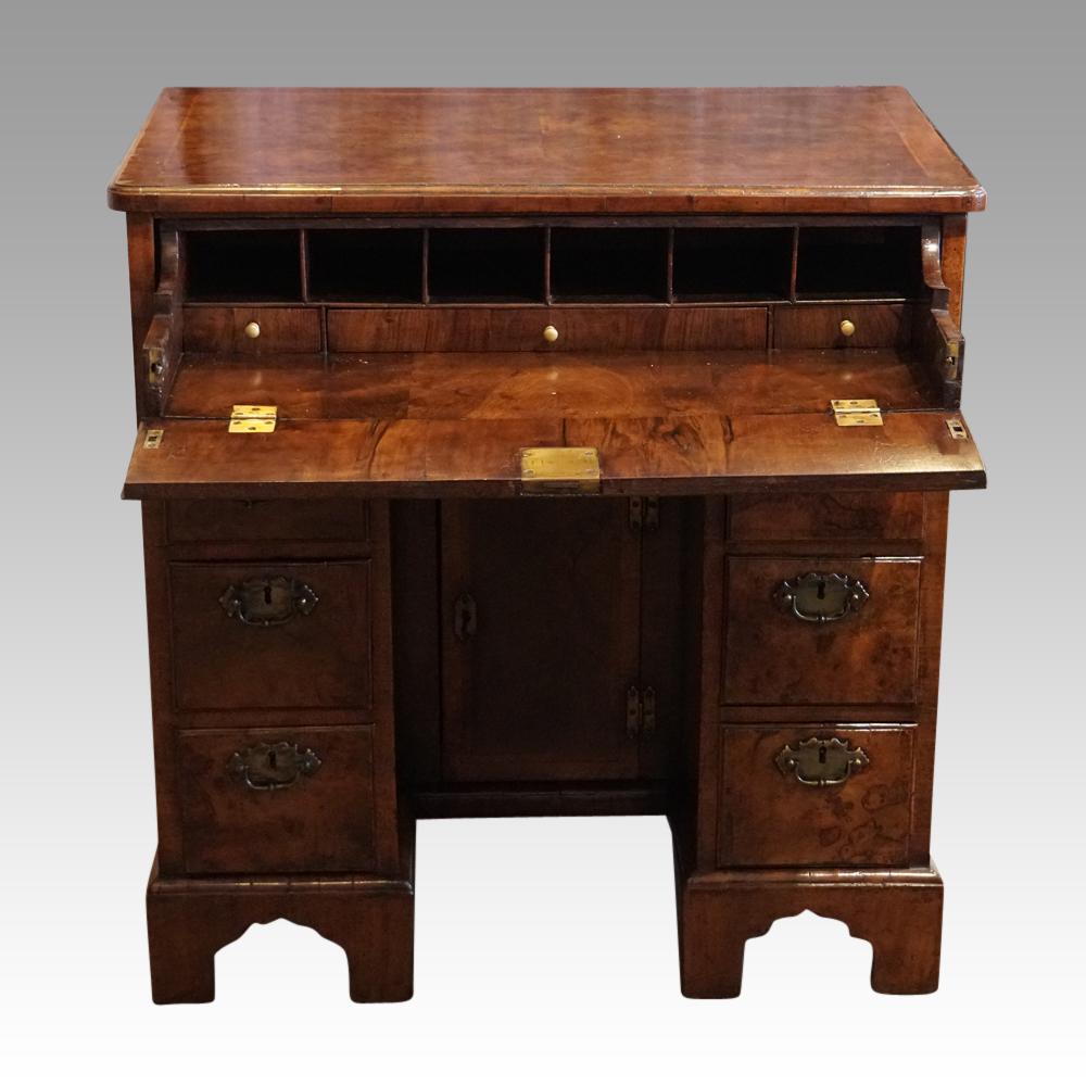 George III walnut knee hole
This George III walnut knee hole was made circa 1760.
The cabinetmaker chose some burr walnut with interesting grain.
The top drawer drops down to reveal the desk interior.
Beneath the fitted long drawer are a bank of