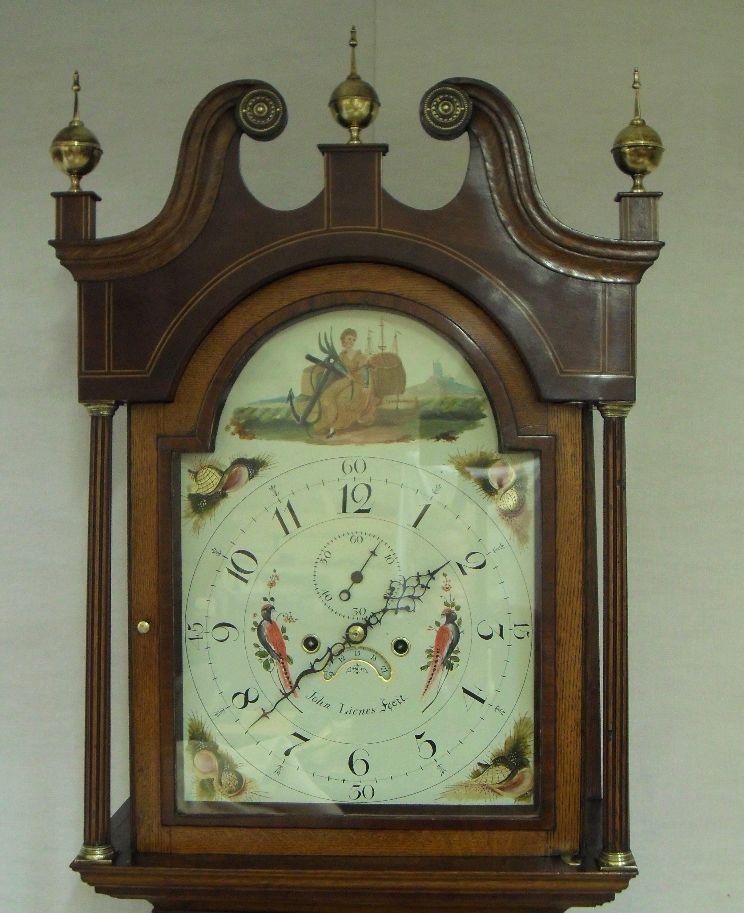 A very nice quality oak and mahogany slim cased Longcase Grandfather clock. The case has mahogany crossbanding to the doors and panels with boxwood and ebony inlay. The case also has fluted quarter columns and swan neck pediment to the hood. The