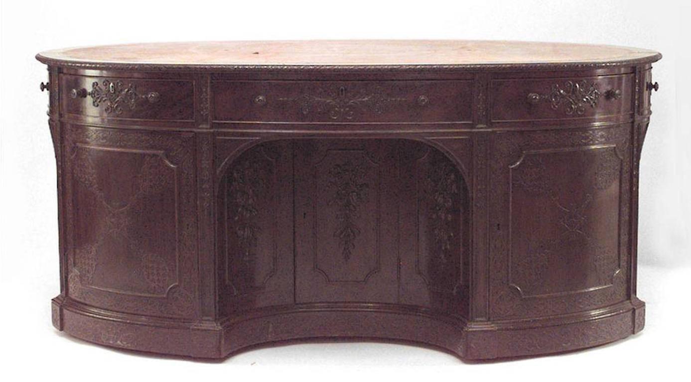 English Georgian (19th century) mahogany oval partners desk with fretwork carved doors and brown leather top.
 