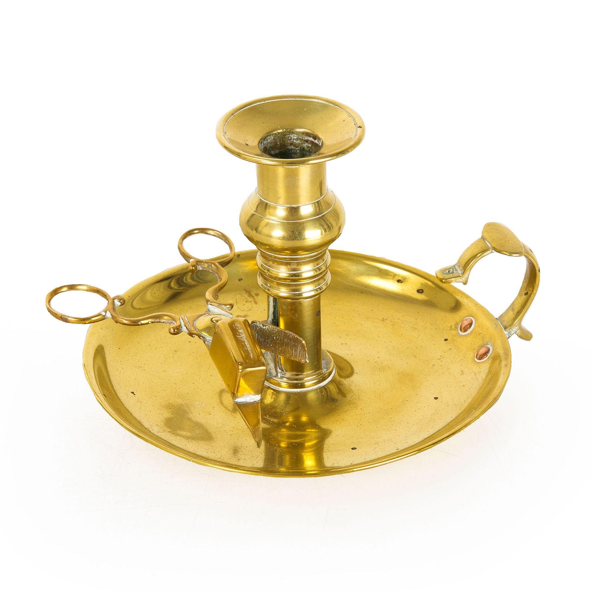 English Georgian Antique Chamberstick Candlestick W/ Wick Trimmer
Item #  107PQP29L-3 

A very nice circular brass chamberstick from the first quarter of the 19th century, it features a working candle ejector and retains an early and likely original