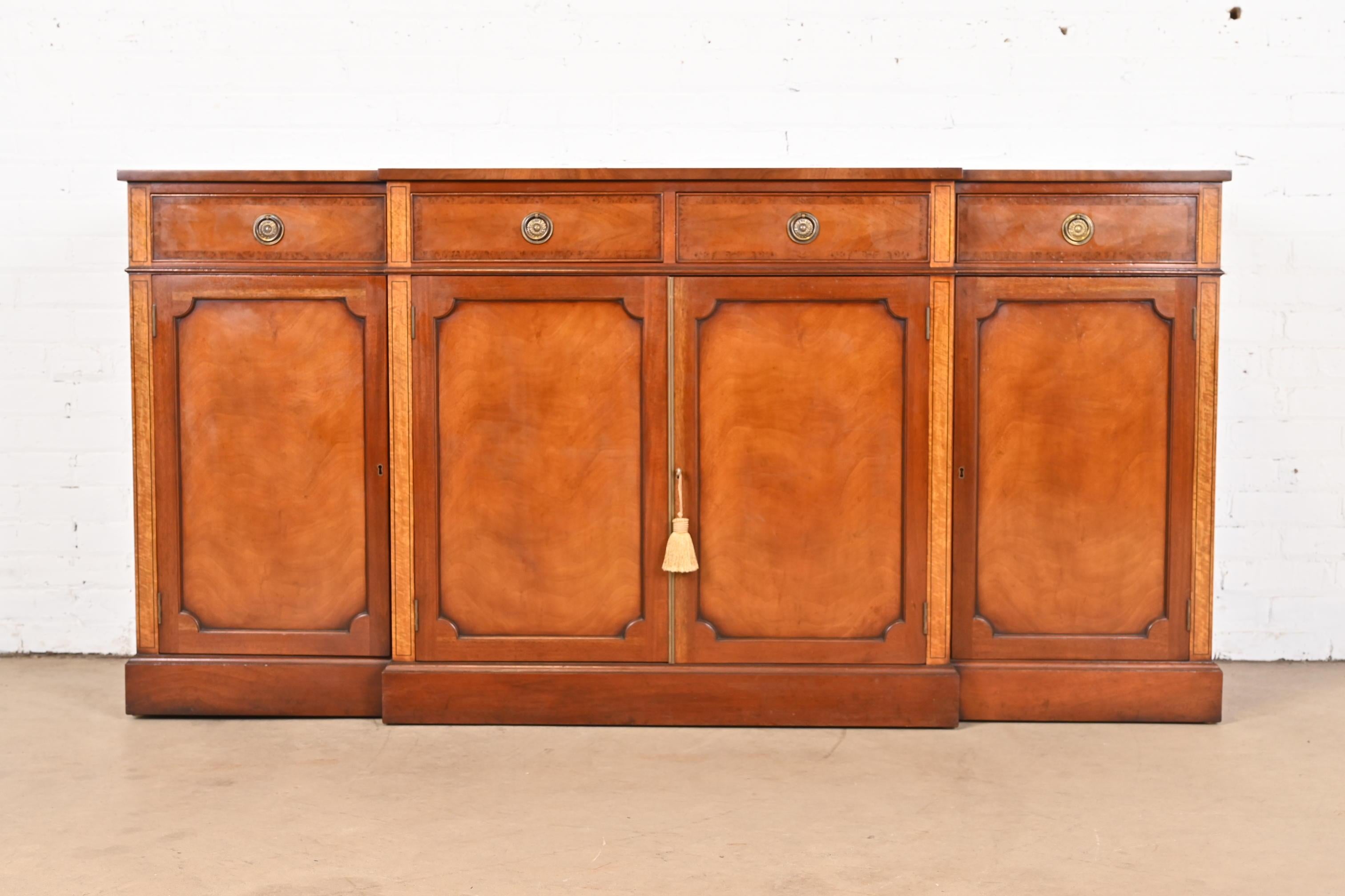 A gorgeous English Georgian or Regency style sideboard, credenza, or bar cabinet

By Restall Brown & Clennell

England, Late 20th Century

Beautiful mahogany, with satinwood and burl wood inlay and banding, and original brass hardware. Cabinets