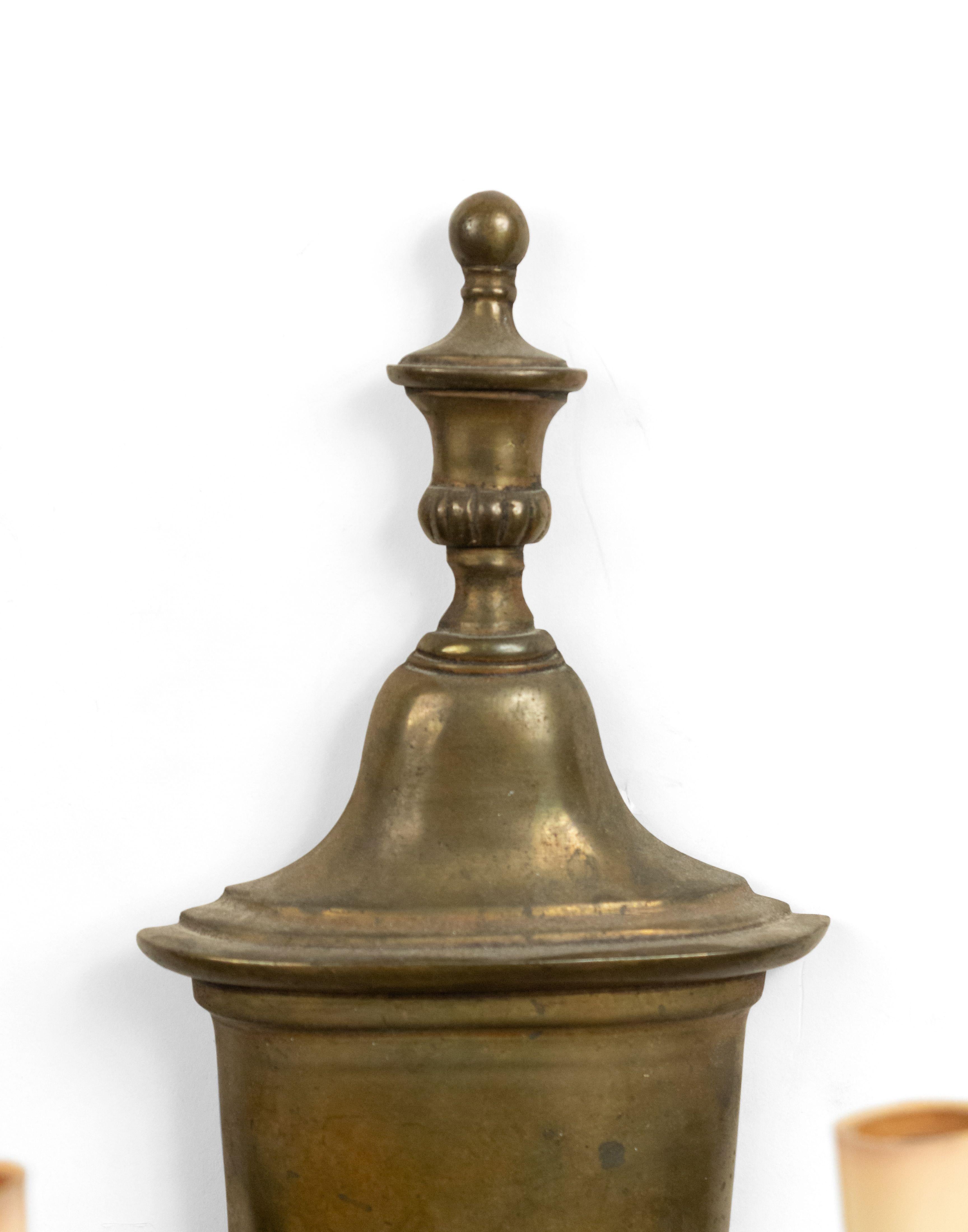 English Georgian style (20th Century) brass urn-shaped wall sconce with two scroll arms and fluted trim.
 