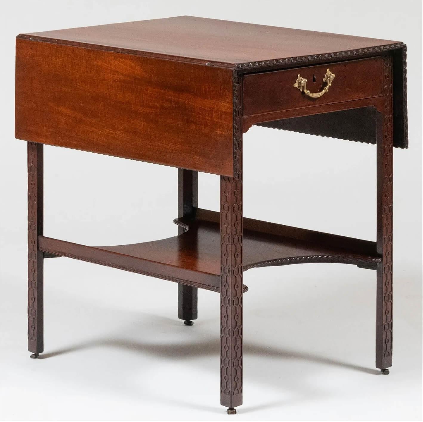 A very fine English late George II, early George III period circa 1760 mahogany Pembroke or drop-leaf table of Chippendale design, the rectangular single-board top with drop-sides and spiral-ribbon carved edges above shallow opposing drawers with