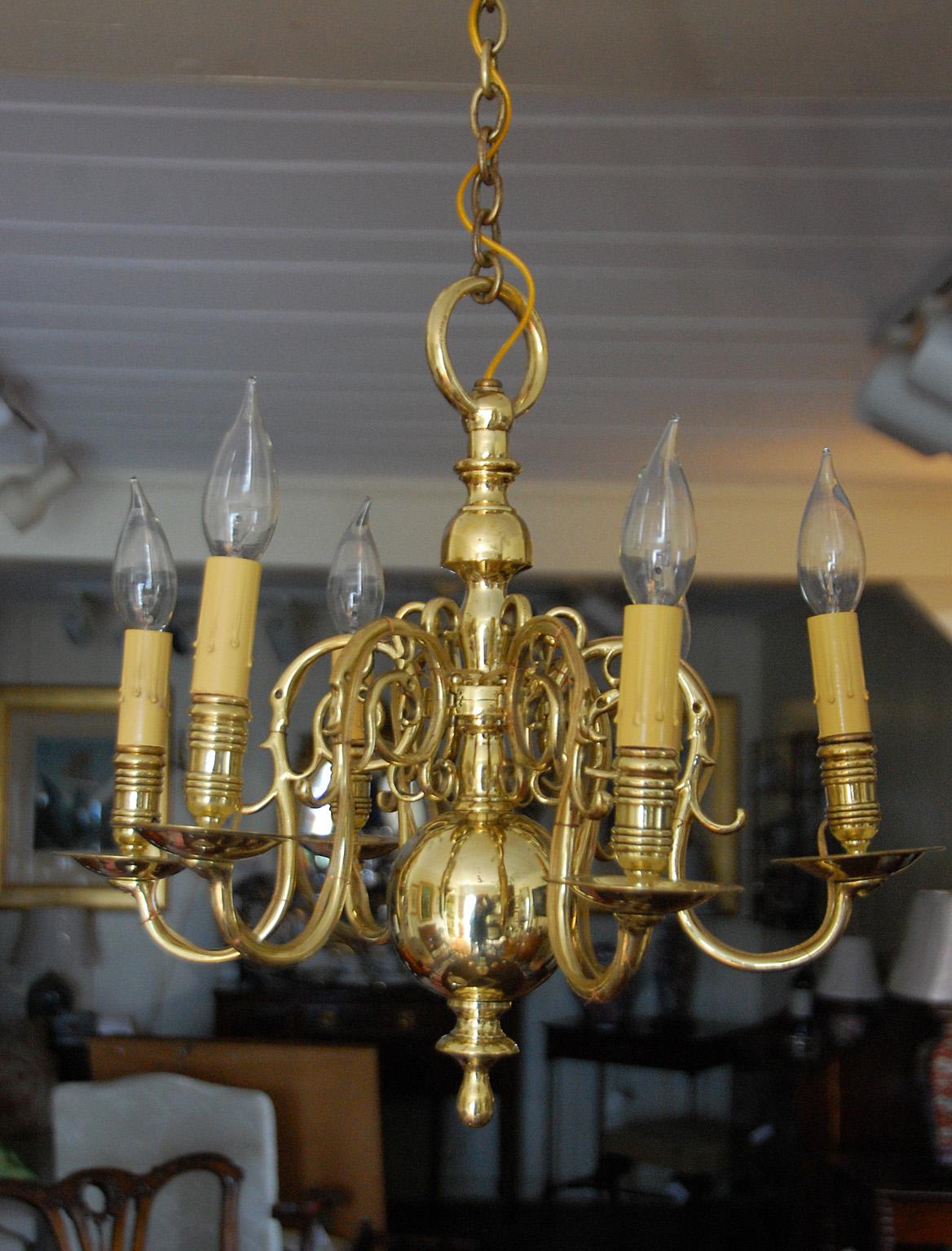 English Chippendale period Georgian brass chandelier with six removable arms (the arms are all pinned with brass pins as one would expect in this period), pendant ball, ringed candleholders. This chandelier has been newly electrified. Circa 1790.