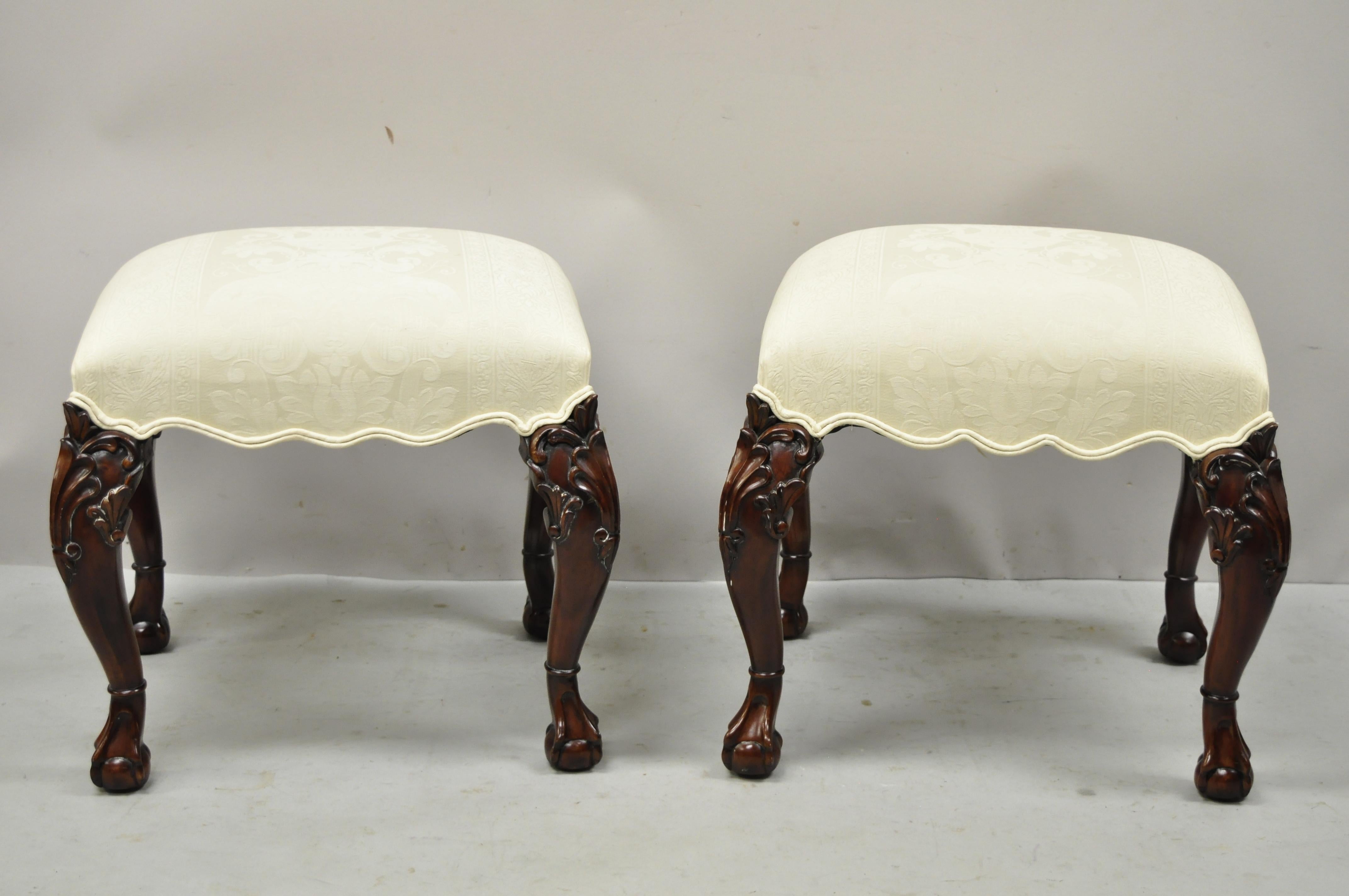 English Georgian Chippendale style carved mahogany ball and claw upholstered stools - a pair. Item features cream damask upholstery, scallop shaped skirt, solid wood construction, beautiful wood grain, nicely carved details, carved ball and claw